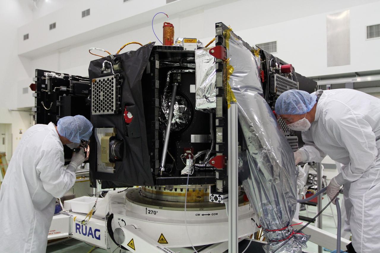 CAPE CANAVERAL, Fla. – Technicians use flashlights to conduct a meticulous inspection of one of NASA's twin Radiation Belt Storm Probes. The spacecraft is secured to a work stand inside the Astrotech payload processing facility near Kennedy Space Center in Florida. The Radiation Belt Storm Probes, or RBSP, mission will help us understand the sun’s influence on Earth and near-Earth space by studying the Earth’s radiation belts on various scales of space and time. RBSP will begin its mission of exploration of Earth's Van Allen radiation belts and the extremes of space weather after its launch aboard a United Launch Alliance Atlas V rocket. For more information, visit http://www.nasa.gov/rbsp. Photo credit: NASA/Kim Shiflett