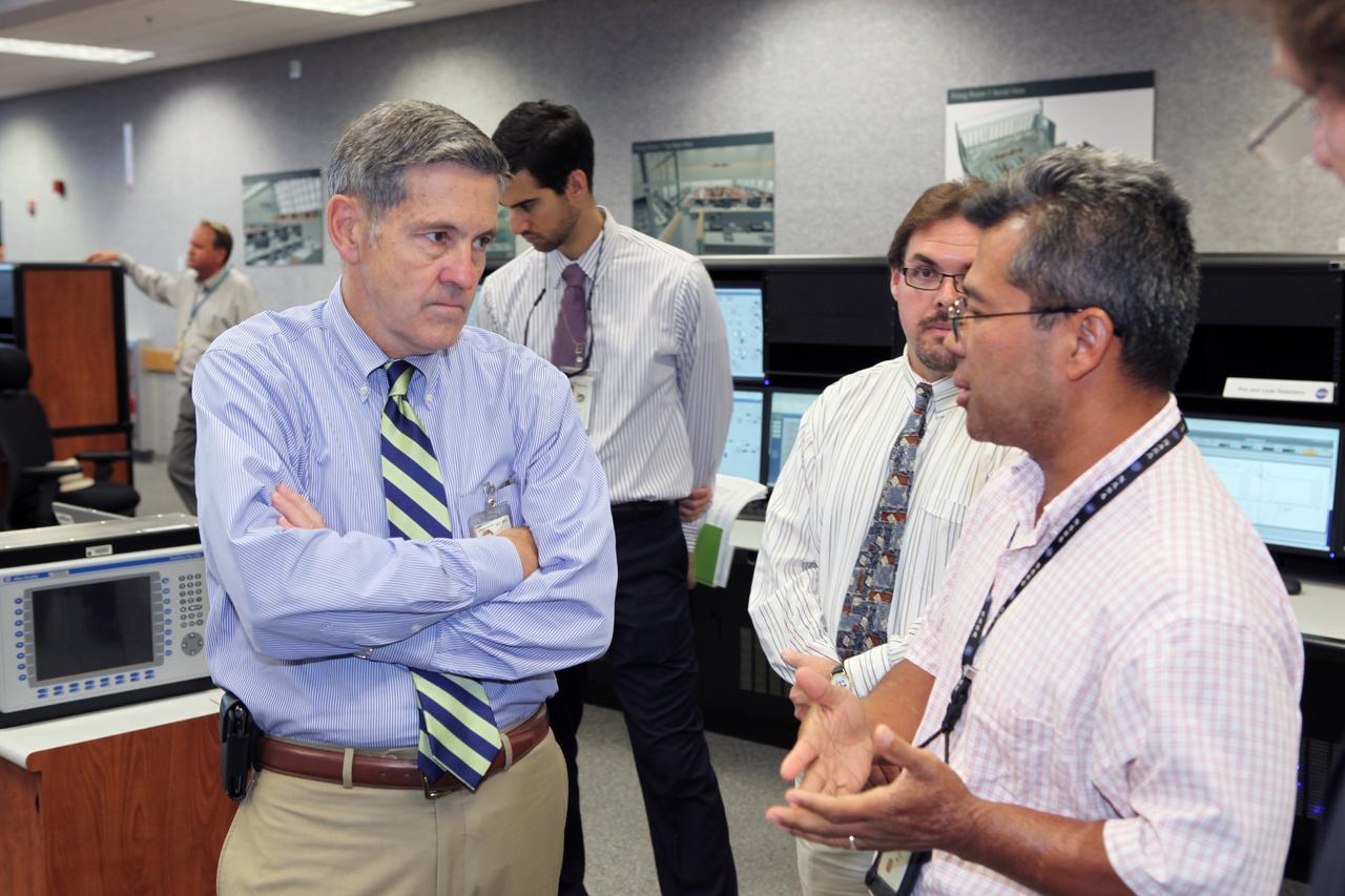 CAPE CANAVERAL, Fla. – Robert Cabana, director of NASA's Kennedy Space Center and a former astronaut, listens to a presentation of new systems installed in the Young-Crippen Firing Room, also known as Firing Room 1, inside the Launch Control Center. The renovation has been led by the Ground Systems Development and Operations Program based at Kennedy. The new systems are designed to be flexible so controllers can process and launch multiple types of rockets and spacecraft, whether they are government or commercial models. Photo credit: NASA/Dmitri Gerondidakis