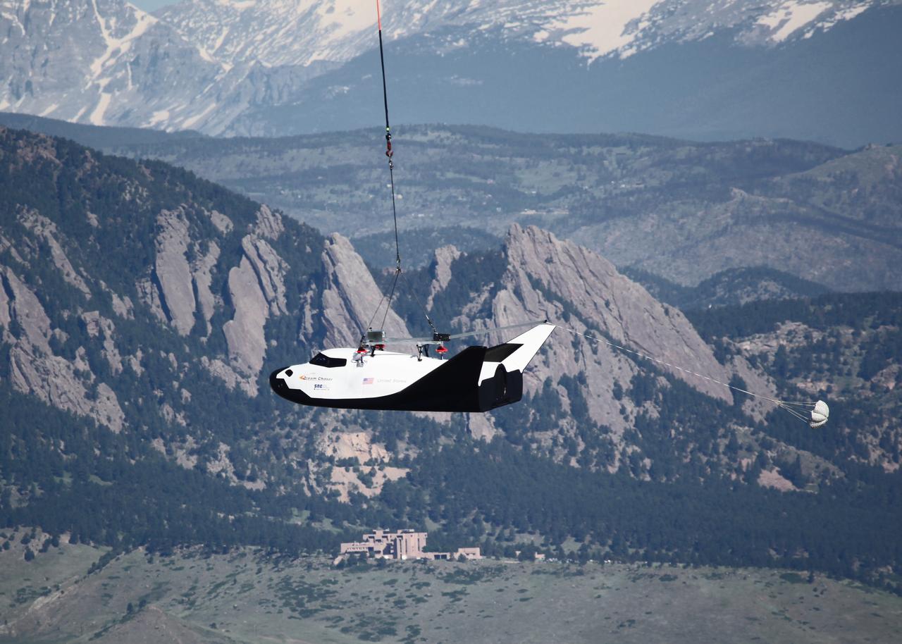LOUISVILLE, Colo. – Sierra Nevada Corporation Space Systems’ Dream Chaser full-scale test vehicle is lifted by an Erickson Air-Crane helicopter to verify proper aerodynamic flight performance near the Rocky Mountain Metropolitan Airport in Jefferson County, Colo. This captive-carry test is one of several milestones the company is meeting during its partnership with NASA’s Commercial Crew Program CCP. Data from this test will provide SNC an early opportunity to evaluate and prove hardware, facilities and ground operations in preparation for approach and landing tests scheduled for later this year.     In 2011, NASA selected Sierra Nevada during Commercial Crew Development Round 2 CCDev2) activities to mature the design and development of a crew transportation system with the overall goal of accelerating a United States-led capability to the International Space Station. The goal of CCP is to drive down the cost of space travel as well as open up space to more people than ever before by balancing industry’s own innovative capabilities with NASA's 50 years of human spaceflight experience. Six other aerospace companies also are maturing launch vehicle and spacecraft designs under CCDev2, including Alliant Techsystems Inc. ATK, The Boeing Co., Excalibur Almaz Inc., Blue Origin, Space Exploration Technologies SpaceX, and United Launch Alliance ULA. For more information, visit www.nasa.gov/commercialcrew. Image credit: Sierra Nevada Corp.