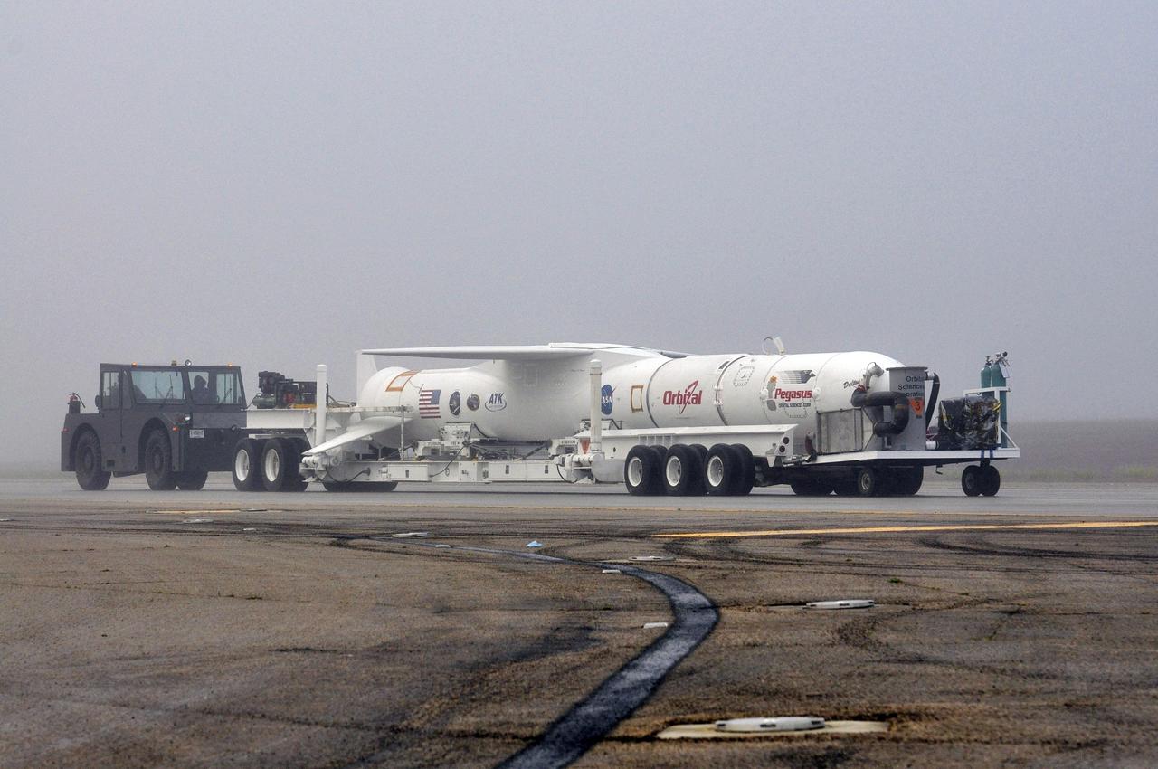 VANDENBERG AFB, Calif. – Technicians roll the Orbital Sciences Pegasus XL rocket with its NuSTAR spacecraft to the waiting L-1011 carrier aircraft known as "Stargazer." The Pegasus will launch NuSTAR into space where the high-energy x-ray telescope will conduct a census for black holes, map radioactive material in young supernovae remnants, and study the origins of cosmic rays and the extreme physics around collapsed stars. Photo credit: NASA/Randy Beaudoin, VAFB