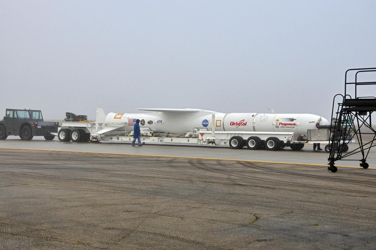 VANDENBERG AFB, Calif. – Technicians roll the Orbital Sciences Pegasus XL rocket with its NuSTAR spacecraft to the waiting L-1011 carrier aircraft known as "Stargazer." The Pegasus will launch NuSTAR into space where the high-energy x-ray telescope will conduct a census for black holes, map radioactive material in young supernovae remnants, and study the origins of cosmic rays and the extreme physics around collapsed stars. Photo credit: NASA/Randy Beaudoin, VAFB