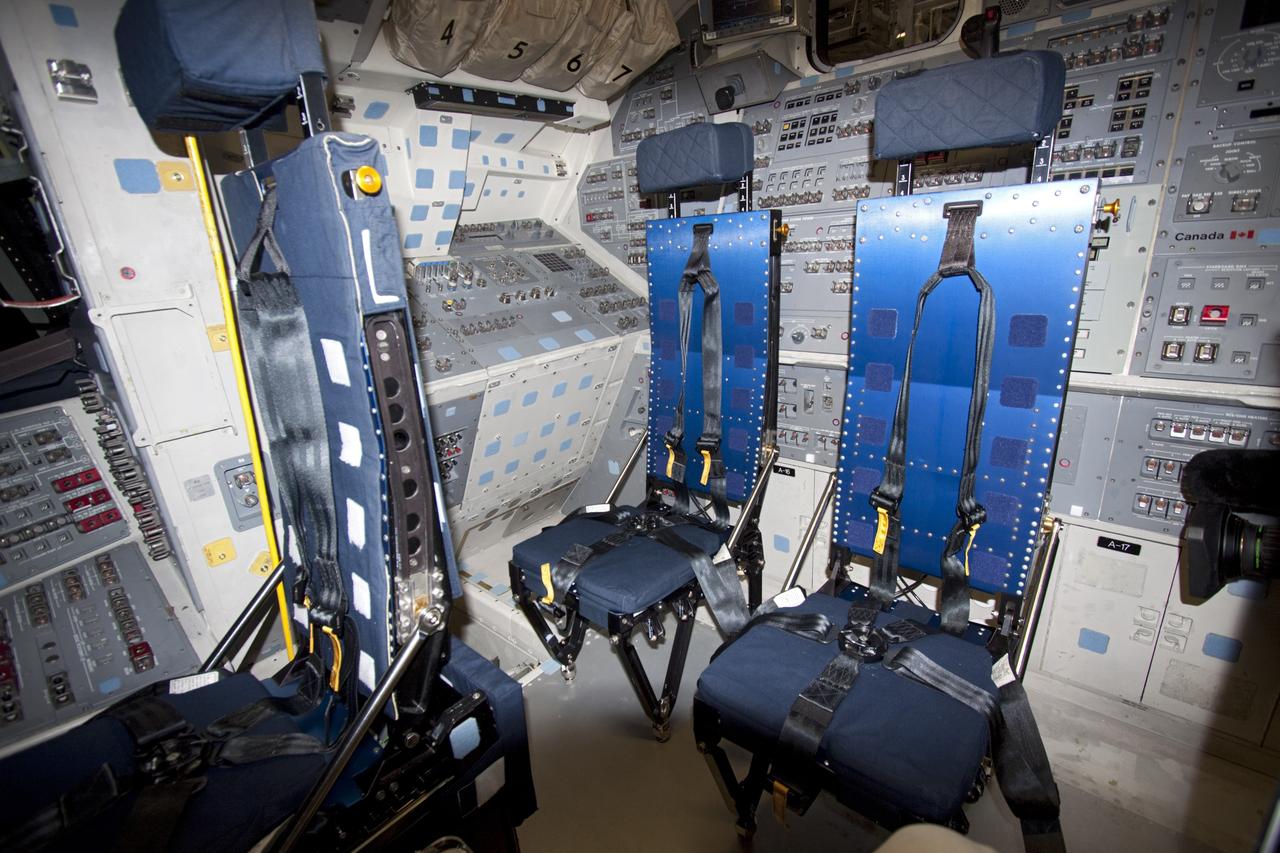The flight deck of space shuttle Atlantis following installation of the crew seats. The spacecraft is prepared for public display. The work is taking place as Atlantis sits inside Orbiter Processing Facility-1 at NASA's Kennedy Space Center in Florida. Photo credit: NASA/Dmitri Gerondidakis