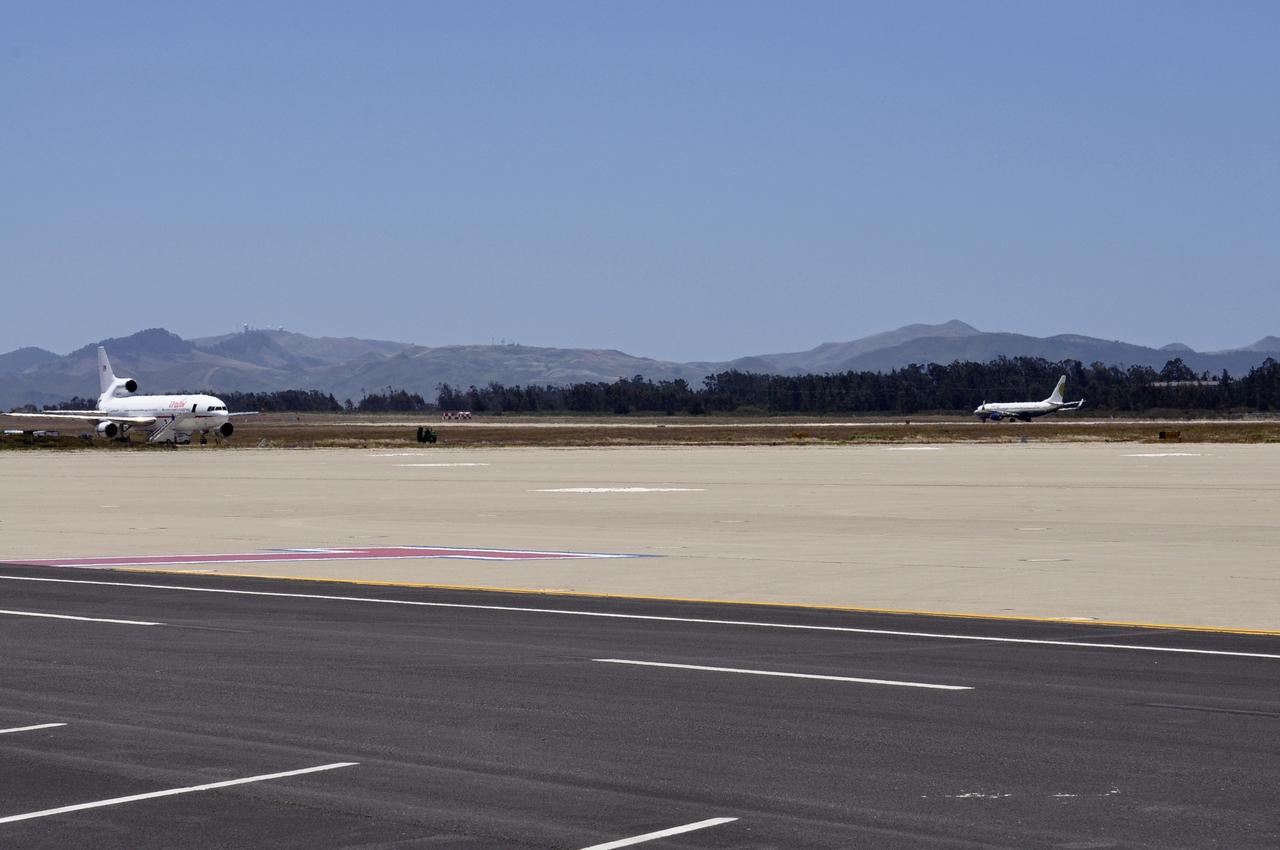 VANDENBERG AIR FORCE BASE, Calif. – The Miami Air International Boeing 737 airplane, at right, accompanying Orbital Sciences’ L-1011 carrier aircraft, prepares for takeoff from Vandenberg Air Force Base in California for the U.S. Army's Ronald Reagan Ballistic Missile Defense Test Site on Kwajalein Atoll, part of the Marshall Islands in the Pacific Ocean.  Forty-nine passengers, including the launch team, are traveling to Kwajalein aboard the charter flight.  The launch team is made up of employees of NASA, Orbital Sciences and a.i. solutions.  Orbital’s L-1011, at left, transporting their Pegasus rocket and NASA’s Nuclear Spectroscopic Telescope Array, or NuSTAR, will follow close behind.      The Pegasus, mated to its NuSTAR payload, will be launched from the carrier aircraft 117 nautical miles south of Kwajalein at latitude 6.75 degrees north of the equator.  The high-energy X-ray telescope will conduct a census of black holes, map radioactive material in young supernovae remnants, and study the origins of cosmic rays and the extreme physics around collapsed stars. Launch is scheduled for June 13.  For more information, visit http://www.nasa.gov/nustar.  Photo credit: NASA/Randy Beaudoin, VAFB
