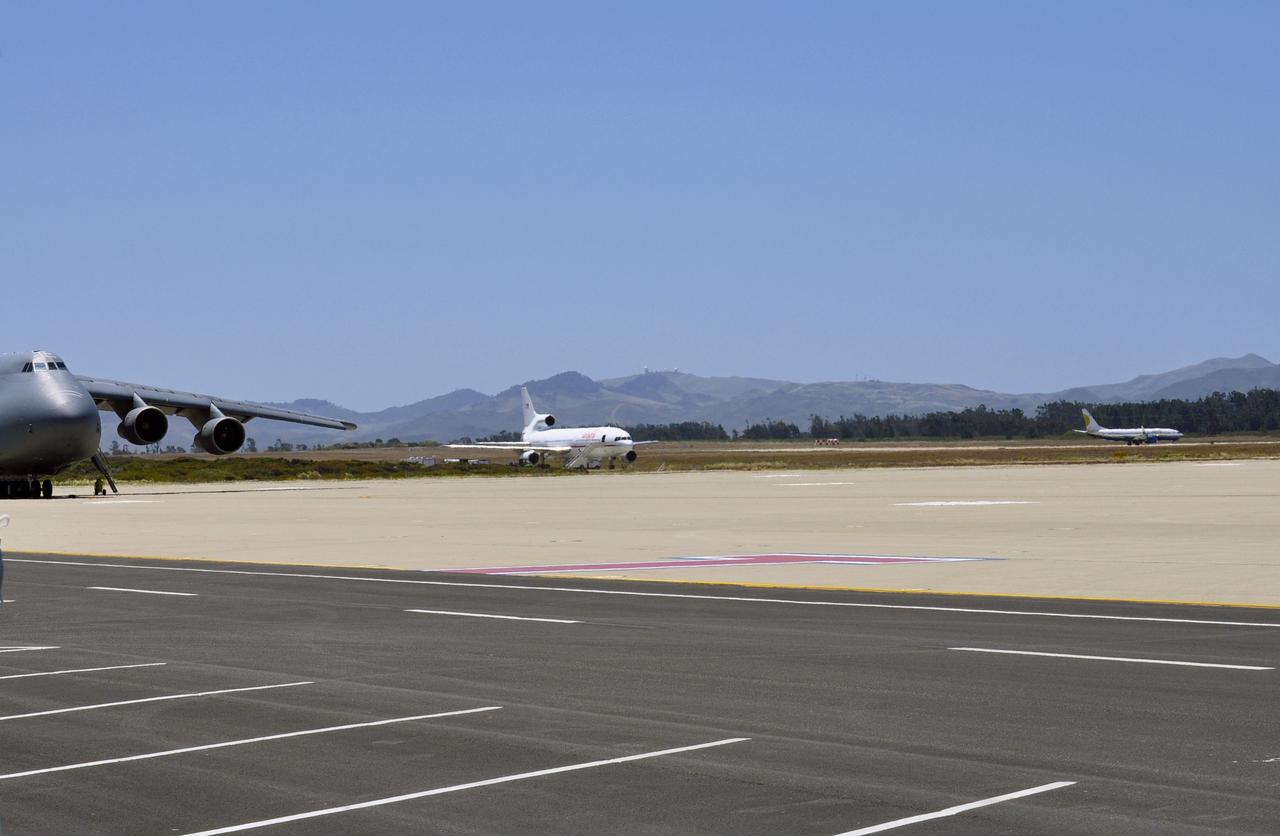 VANDENBERG AIR FORCE BASE, Calif. – The Miami Air International Boeing 737 airplane, at right, accompanying Orbital Sciences’ L-1011 carrier aircraft, takes off from Vandenberg Air Force Base in California for the U.S. Army's Ronald Reagan Ballistic Missile Defense Test Site on Kwajalein Atoll, part of the Marshall Islands in the Pacific Ocean. Forty-nine passengers, including the launch team, are traveling to Kwajalein aboard the charter flight. The launch team is made up of employees of NASA, Orbital Sciences and a.i. solutions. Orbital’s L-1011, at left, transporting their Pegasus rocket and NASA’s Nuclear Spectroscopic Telescope Array, or NuSTAR, will follow close behind. The Pegasus, mated to its NuSTAR payload, will be launched from the carrier aircraft 117 nautical miles south of Kwajalein at latitude 6.75 degrees north of the equator. The high-energy X-ray telescope will conduct a census of black holes, map radioactive material in young supernovae remnants, and study the origins of cosmic rays and the extreme physics around collapsed stars. Launch is scheduled for June 13. For more information, visit http://www.nasa.gov/nustar. Photo credit: NASA/Randy Beaudoin, VAFB