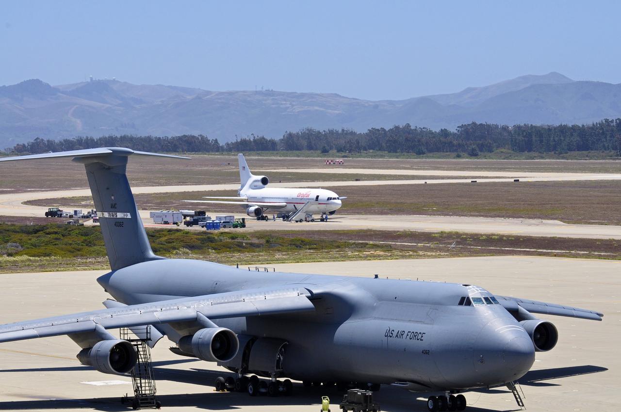 VANDENBERG AIR FORCE BASE, Calif. – A U.S. Air Force C-5 Galaxy cargo aircraft, foreground, sits on the tarmac at Vandenberg Air Force Base in California as final preparations are under way for the departure of Orbital Sciences’ L-1011 carrier aircraft for the U.S. Army's Ronald Reagan Ballistic Missile Defense Test Site on Kwajalein Atoll, part of the Marshall Islands in the Pacific Ocean.  Orbital’s L-1011 is transporting their Pegasus rocket and NASA’s Nuclear Spectroscopic Telescope Array, or NuSTAR, to Kwajalein for launch.     The Pegasus, mated to its NuSTAR payload, will be launched from the carrier aircraft 117 nautical miles south of Kwajalein at latitude 6.75 degrees north of the equator.  The high-energy X-ray telescope will conduct a census of black holes, map radioactive material in young supernovae remnants, and study the origins of cosmic rays and the extreme physics around collapsed stars. Launch is scheduled for June 13.  For more information, visit http://www.nasa.gov/nustar.  Photo credit: NASA/Randy Beaudoin, VAFB