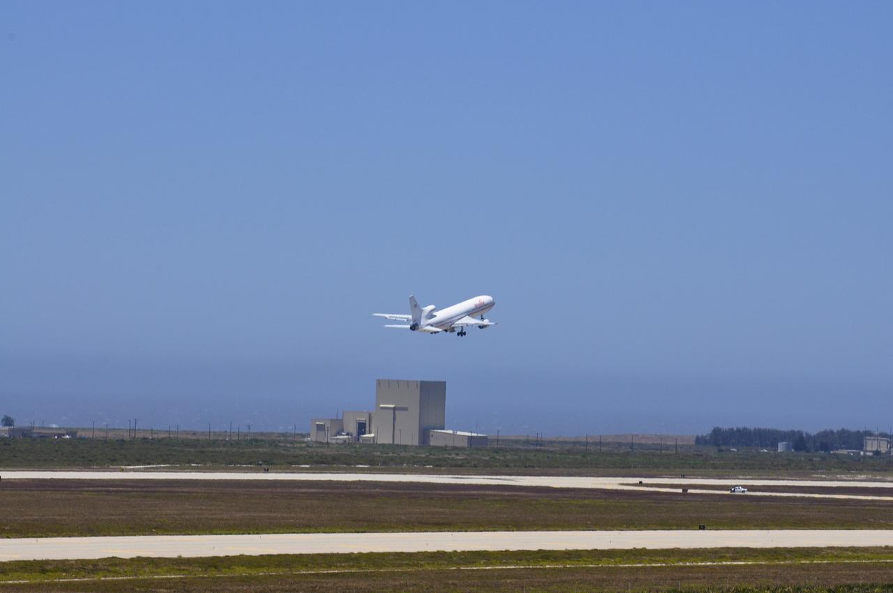 VANDENBERG AIR FORCE BASE, Calif. – Orbital Sciences’ L-1011 carrier aircraft, transporting Orbital’s Pegasus rocket and NASA’s Nuclear Spectroscopic Telescope Array, or NuSTAR, takes off from Vandenberg Air Force Base in California for the U.S. Army's Ronald Reagan Ballistic Missile Defense Test Site on Kwajalein Atoll, part of the Marshall Islands in the Pacific Ocean.  In the background is Orbital Sciences’ processing facility where the Pegasus and NuSTAR were prepared for launch.      The Pegasus, mated to its NuSTAR payload, will be launched from the carrier aircraft 117 nautical miles south of Kwajalein at latitude 6.75 degrees north of the equator.  The high-energy X-ray telescope will conduct a census of black holes, map radioactive material in young supernovae remnants, and study the origins of cosmic rays and the extreme physics around collapsed stars. Launch is scheduled for June 13.  For more information, visit http://www.nasa.gov/nustar.  Photo credit: NASA/Randy Beaudoin, VAFB