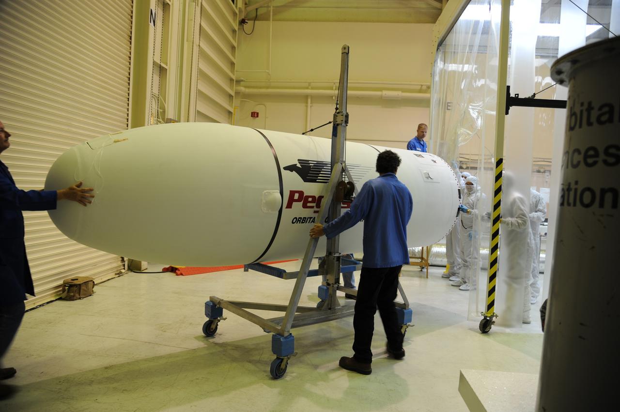 VANDENBERG AIR FORCE BASE, Calif. – In Orbital Sciences’ hangar on Vandenberg Air Force Base in California, technicians roll the second half of the Pegasus fairing into an environmental enclosure for reinstallation around NASA’s Nuclear Spectroscopic Telescope Array, or NuSTAR.        Access to the spacecraft was needed for compatibility testing to verify communication with a tracking station in Hawaii. With the change in the launch timeframe to June, this station will be needed to support launch.  After processing of Orbital’s Pegasus XL rocket and the spacecraft is complete, they will be flown on Orbital's L-1011 carrier aircraft from Vandenberg, to the U.S. Army's Ronald Reagan Ballistic Missile Defense Test Site on Kwajalein Atoll, part of the Marshall Islands in the Pacific Ocean.  The Pegasus, mated to its NuSTAR payload, will be launched from the carrier aircraft 117 nautical miles south of Kwajalein at latitude 6.75 degrees north of the equator.  The high-energy X-ray telescope will conduct a census of black holes, map radioactive material in young supernovae remnants, and study the origins of cosmic rays and the extreme physics around collapsed stars. Launch is scheduled for June 13.  For more information, visit http://www.nasa.gov/nustar.  Photo credit: U.S. Air Force 30th Space Wing/Aaron Taubman, VAFB
