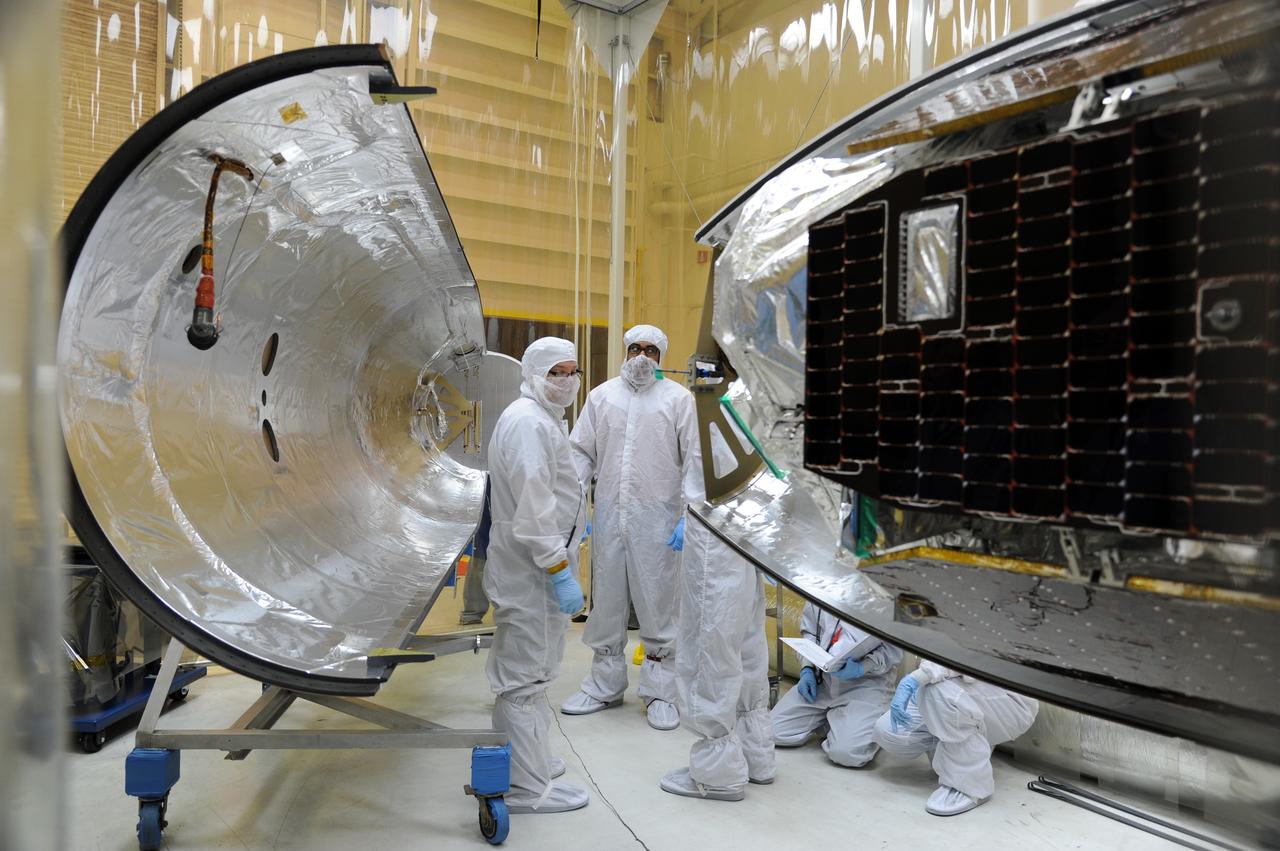 VANDENBERG AIR FORCE BASE, Calif. – In Orbital Sciences’ hangar on Vandenberg Air Force Base in California, technicians have reinstalled half of the Pegasus fairing around NASA’s Nuclear Spectroscopic Telescope Array, or NuSTAR, and prepare to reinstall the other half.         Access to the spacecraft was needed for compatibility testing to verify communication with a tracking station in Hawaii. With the change in the launch timeframe to June, this station will be needed to support launch.  After processing of Orbital’s Pegasus XL rocket and the spacecraft is complete, they will be flown on Orbital's L-1011 carrier aircraft from Vandenberg, to the U.S. Army's Ronald Reagan Ballistic Missile Defense Test Site on Kwajalein Atoll, part of the Marshall Islands in the Pacific Ocean.  The Pegasus, mated to its NuSTAR payload, will be launched from the carrier aircraft 117 nautical miles south of Kwajalein at latitude 6.75 degrees north of the equator.  The high-energy X-ray telescope will conduct a census of black holes, map radioactive material in young supernovae remnants, and study the origins of cosmic rays and the extreme physics around collapsed stars. Launch is scheduled for June 13.  For more information, visit http://www.nasa.gov/nustar.  Photo credit: U.S. Air Force 30th Space Wing/Aaron Taubman, VAFB