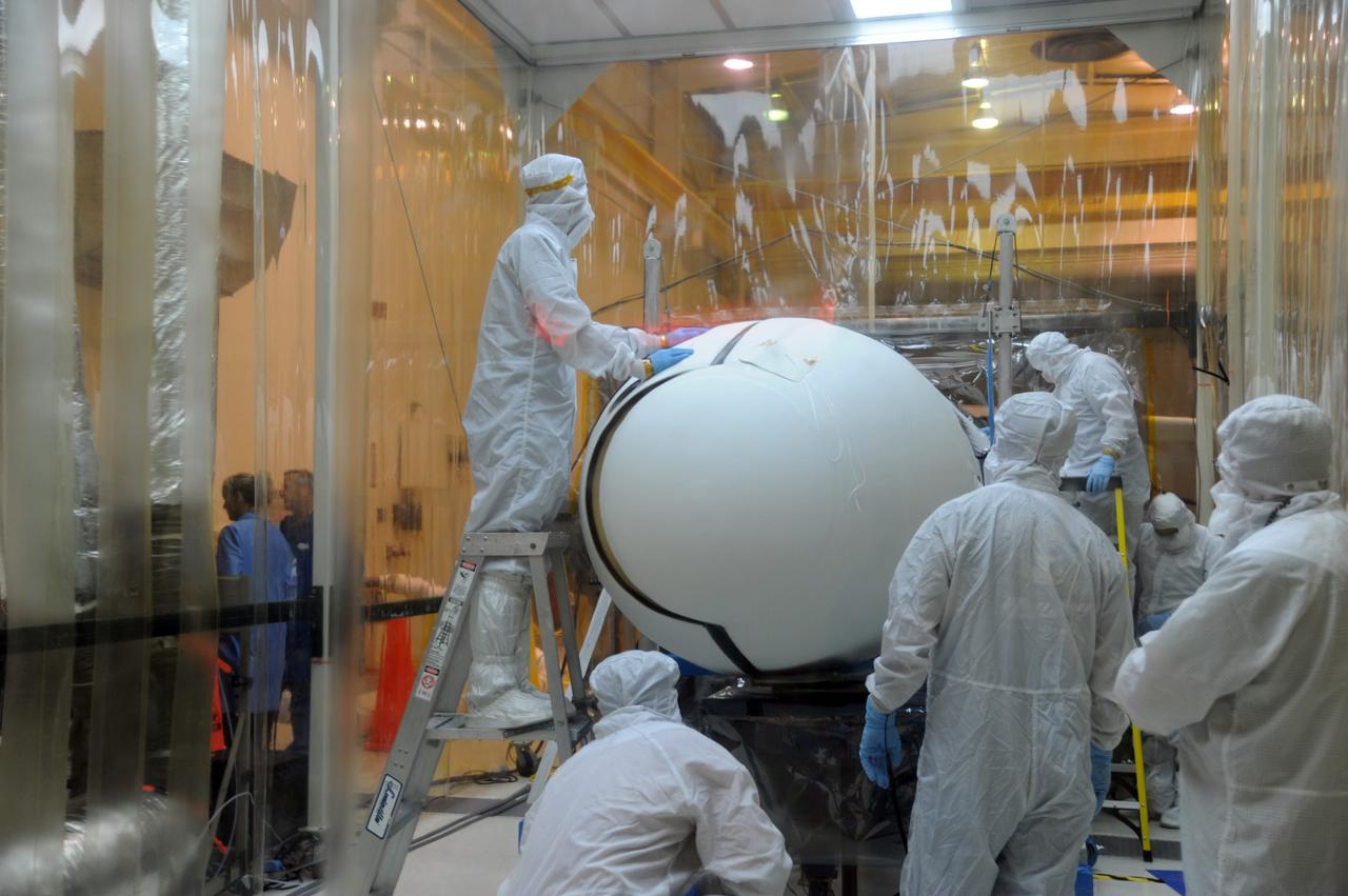 VANDENBERG AIR FORCE BASE, Calif. – In Orbital Sciences’ hangar on Vandenberg Air Force Base in California, NASA’s Nuclear Spectroscopic Telescope Array, or NuSTAR, is hidden from sight as the Pegasus fairing closes around it during the fairing’s reinstallation.    Access to the spacecraft was needed for compatibility testing to verify communication with a tracking station in Hawaii. With the change in the launch timeframe to June, this station will be needed to support launch.  After processing of Orbital’s Pegasus XL rocket and the spacecraft is complete, they will be flown on Orbital's L-1011 carrier aircraft from Vandenberg, to the U.S. Army's Ronald Reagan Ballistic Missile Defense Test Site on Kwajalein Atoll, part of the Marshall Islands in the Pacific Ocean.  The Pegasus, mated to its NuSTAR payload, will be launched from the carrier aircraft 117 nautical miles south of Kwajalein at latitude 6.75 degrees north of the equator.  The high-energy X-ray telescope will conduct a census of black holes, map radioactive material in young supernovae remnants, and study the origins of cosmic rays and the extreme physics around collapsed stars. Launch is scheduled for June 13.  For more information, visit http://www.nasa.gov/nustar.  Photo credit: U.S. Air Force 30th Space Wing/Aaron Taubman, VAFB