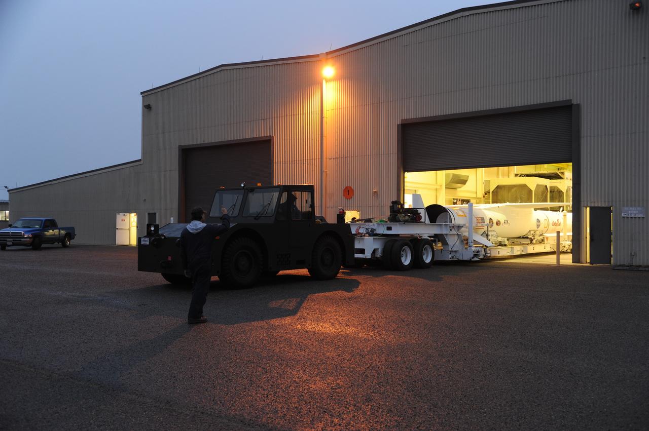 VANDENBERG AIR FORCE BASE, Calif. – NASA’s Nuclear Spectroscopic Telescope Array, or NuSTAR, mated to Orbital Sciences’ Pegasus XL rocket, rolls out of Orbital’s processing hangar headed for the “hot pad,” located on the ramp adjacent to the runway on Vandenberg Air Force Base in California.  At the hot pad, the rocket will be attached beneath Orbital’s L-1011 carrier aircraft.      The duo will be flown from Vandenberg to the U.S. Army's Ronald Reagan Ballistic Missile Defense Test Site on Kwajalein Atoll, part of the Marshall Islands in the Pacific Ocean.  The Pegasus and its NuSTAR payload will be launched June 13 from the carrier aircraft 117 nautical miles south of Kwajalein at latitude 6.75 degrees north of the equator.  The high-energy X-ray telescope will conduct a census of black holes, map radioactive material in young supernovae remnants, and study the origins of cosmic rays and the extreme physics around collapsed stars. For more information, visit http://www.nasa.gov/nustar.  Photo credit: NASA/Chris Wiant, VAFB