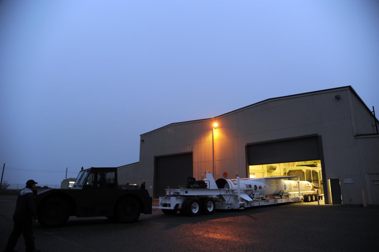 VANDENBERG AIR FORCE BASE, Calif. – NASA’s Nuclear Spectroscopic Telescope Array, or NuSTAR, mated to Orbital Sciences’ Pegasus XL rocket, rolls out of Orbital’s processing hangar headed for the “hot pad,” located on the ramp adjacent to the runway on Vandenberg Air Force Base in California.  At the hot pad, the rocket will be attached beneath Orbital’s L-1011 carrier aircraft.      The duo will be flown from Vandenberg to the U.S. Army's Ronald Reagan Ballistic Missile Defense Test Site on Kwajalein Atoll, part of the Marshall Islands in the Pacific Ocean.  The Pegasus and its NuSTAR payload will be launched June 13 from the carrier aircraft 117 nautical miles south of Kwajalein at latitude 6.75 degrees north of the equator.  The high-energy X-ray telescope will conduct a census of black holes, map radioactive material in young supernovae remnants, and study the origins of cosmic rays and the extreme physics around collapsed stars. For more information, visit http://www.nasa.gov/nustar.  Photo credit: NASA/Chris Wiant, VAFB
