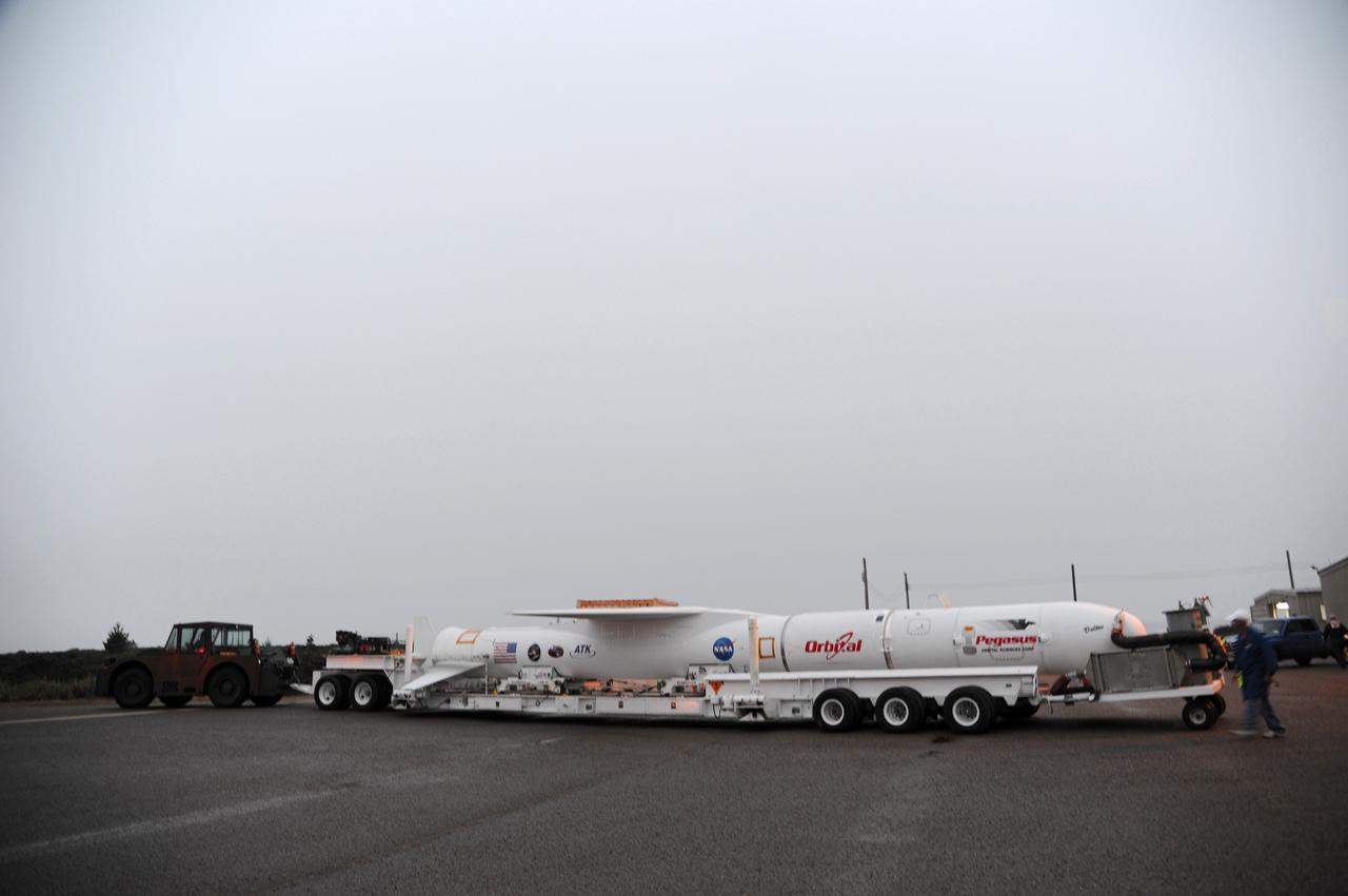 VANDENBERG AIR FORCE BASE, Calif. – NASA’s Nuclear Spectroscopic Telescope Array, or NuSTAR, mated to Orbital Sciences’ Pegasus XL rocket, is transported from Orbital’s processing hangar to the “hot pad,” located on the ramp adjacent to the runway on Vandenberg Air Force Base in California.  At the hot pad, the rocket will be attached beneath Orbital’s L-1011 carrier aircraft.      The duo will be flown from Vandenberg to the U.S. Army's Ronald Reagan Ballistic Missile Defense Test Site on Kwajalein Atoll, part of the Marshall Islands in the Pacific Ocean.  The Pegasus and its NuSTAR payload will be launched June 13 from the carrier aircraft 117 nautical miles south of Kwajalein at latitude 6.75 degrees north of the equator.  The high-energy X-ray telescope will conduct a census of black holes, map radioactive material in young supernovae remnants, and study the origins of cosmic rays and the extreme physics around collapsed stars. For more information, visit http://www.nasa.gov/nustar.  Photo credit: NASA/Chris Wiant, VAFB