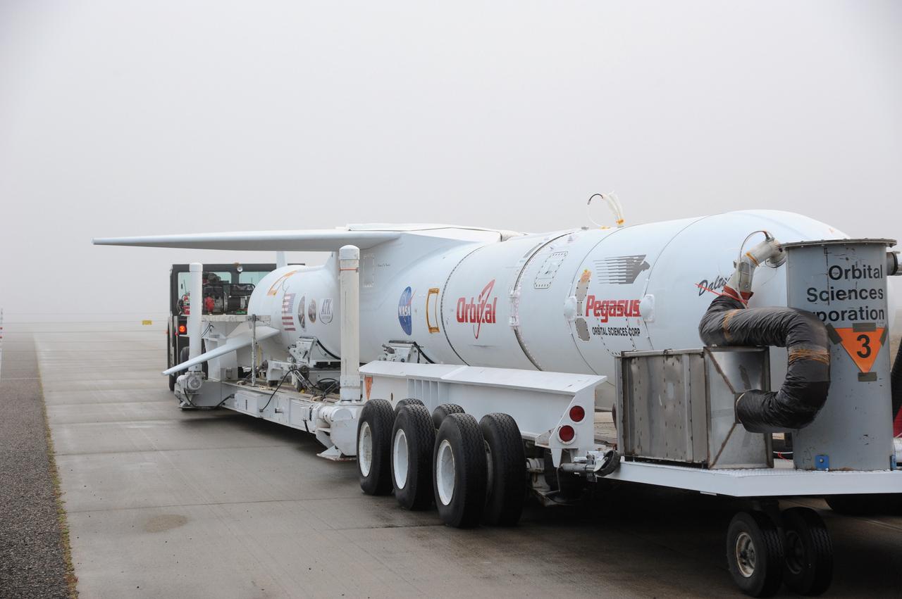 VANDENBERG AIR FORCE BASE, Calif. – Fog engulfs NASA’s Nuclear Spectroscopic Telescope Array, or NuSTAR, mated to Orbital Sciences’ Pegasus XL rocket, as it arrives at the “hot pad,” located on the ramp adjacent to the runway on Vandenberg Air Force Base in California.  At the hot pad, the rocket will be attached beneath Orbital’s L-1011 carrier aircraft.      The duo will be flown from Vandenberg to the U.S. Army's Ronald Reagan Ballistic Missile Defense Test Site on Kwajalein Atoll, part of the Marshall Islands in the Pacific Ocean.  The Pegasus and its NuSTAR payload will be launched June 13 from the carrier aircraft 117 nautical miles south of Kwajalein at latitude 6.75 degrees north of the equator.  The high-energy X-ray telescope will conduct a census of black holes, map radioactive material in young supernovae remnants, and study the origins of cosmic rays and the extreme physics around collapsed stars. For more information, visit http://www.nasa.gov/nustar.  Photo credit: NASA/Chris Wiant, VAFB