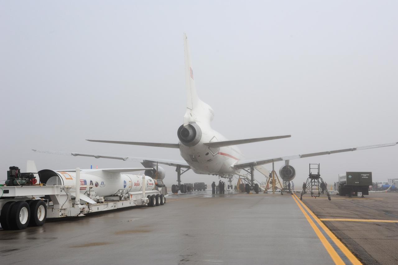 VANDENBERG AIR FORCE BASE, Calif. – NASA’s Nuclear Spectroscopic Telescope Array, or NuSTAR, mated to Orbital Sciences’ Pegasus XL rocket, approaches Orbital’s L-1011 carrier aircraft awaiting its arrival at the “hot pad,” located on the ramp adjacent to the runway on Vandenberg Air Force Base in California.  The rocket will be attached beneath the L-1011 aircraft.    The duo will be flown from Vandenberg to the U.S. Army's Ronald Reagan Ballistic Missile Defense Test Site on Kwajalein Atoll, part of the Marshall Islands in the Pacific Ocean.  The Pegasus and its NuSTAR payload will be launched June 13 from the carrier aircraft 117 nautical miles south of Kwajalein at latitude 6.75 degrees north of the equator.  The high-energy X-ray telescope will conduct a census of black holes, map radioactive material in young supernovae remnants, and study the origins of cosmic rays and the extreme physics around collapsed stars. For more information, visit http://www.nasa.gov/nustar.  Photo credit: NASA/Chris Wiant, VAFB