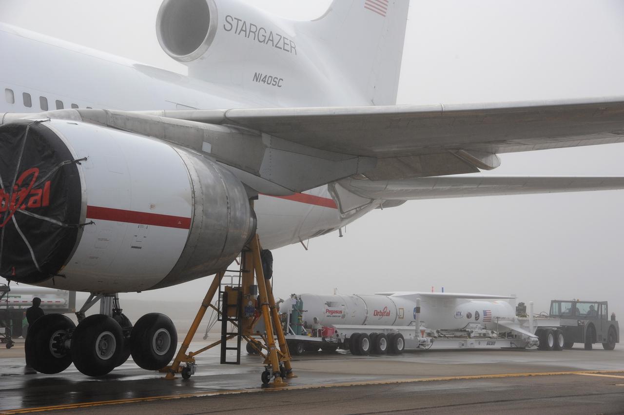VANDENBERG AIR FORCE BASE, Calif. – NASA’s Nuclear Spectroscopic Telescope Array, or NuSTAR, mated to Orbital Sciences’ Pegasus XL rocket, rolls toward Orbital’s L-1011 carrier aircraft at the “hot pad,” located on the ramp adjacent to the runway on Vandenberg Air Force Base in California.  Operations are under way to attach the rocket beneath the L-1011 aircraft.    The duo will be flown from Vandenberg to the U.S. Army's Ronald Reagan Ballistic Missile Defense Test Site on Kwajalein Atoll, part of the Marshall Islands in the Pacific Ocean.  The Pegasus and its NuSTAR payload will be launched June 13 from the carrier aircraft 117 nautical miles south of Kwajalein at latitude 6.75 degrees north of the equator.  The high-energy X-ray telescope will conduct a census of black holes, map radioactive material in young supernovae remnants, and study the origins of cosmic rays and the extreme physics around collapsed stars. For more information, visit http://www.nasa.gov/nustar.  Photo credit: NASA/Chris Wiant, VAFB