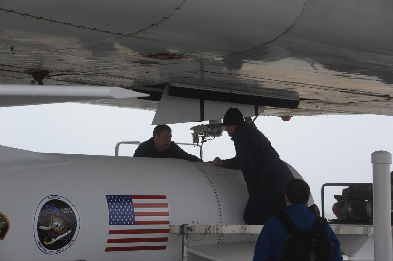 VANDENBERG AIR FORCE BASE, Calif. – Technicians prepare to attach NASA’s Nuclear Spectroscopic Telescope Array, or NuSTAR, mated to Orbital Sciences’ Pegasus XL rocket, beneath Orbital’s L-1011 carrier aircraft at the “hot pad,” located on the ramp adjacent to the runway on Vandenberg Air Force Base in California.      The duo will be flown from Vandenberg to the U.S. Army's Ronald Reagan Ballistic Missile Defense Test Site on Kwajalein Atoll, part of the Marshall Islands in the Pacific Ocean.  The Pegasus and its NuSTAR payload will be launched June 13 from the carrier aircraft 117 nautical miles south of Kwajalein at latitude 6.75 degrees north of the equator.  The high-energy X-ray telescope will conduct a census of black holes, map radioactive material in young supernovae remnants, and study the origins of cosmic rays and the extreme physics around collapsed stars. For more information, visit http://www.nasa.gov/nustar.  Photo credit: NASA/Chris Wiant, VAFB