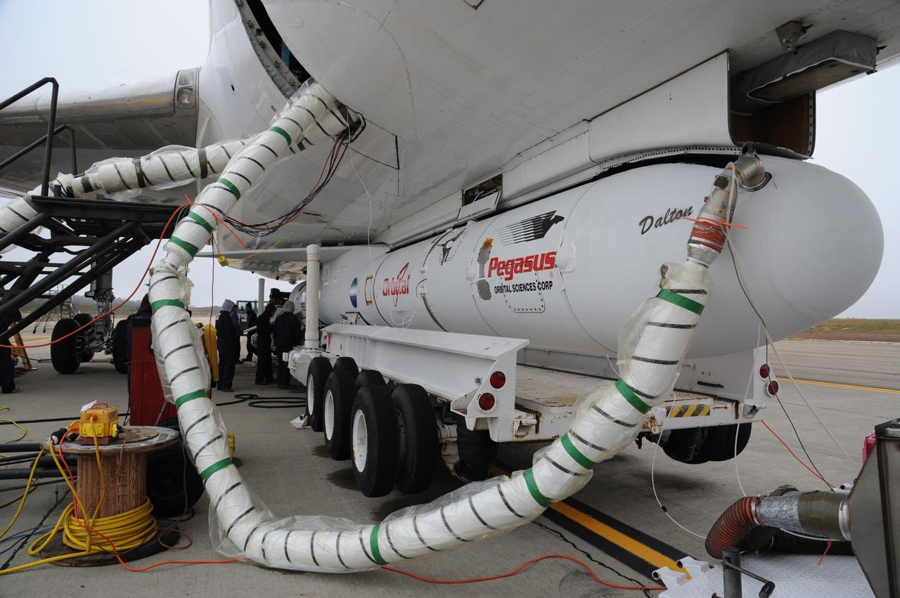 VANDENBERG AIR FORCE BASE, Calif. – A coolant line is connected to the fairing enclosing  NASA’s Nuclear Spectroscopic Telescope Array, or NuSTAR, after the Orbital Sciences’ Pegasus XL rocket to which it is mated is attached beneath Orbital’s L-1011 carrier aircraft at the “hot pad,” located on the ramp adjacent to the runway on Vandenberg Air Force Base in California.    The duo will be flown from Vandenberg to the U.S. Army's Ronald Reagan Ballistic Missile Defense Test Site on Kwajalein Atoll, part of the Marshall Islands in the Pacific Ocean.  The Pegasus and its NuSTAR payload will be launched June 13 from the carrier aircraft 117 nautical miles south of Kwajalein at latitude 6.75 degrees north of the equator.  The high-energy X-ray telescope will conduct a census of black holes, map radioactive material in young supernovae remnants, and study the origins of cosmic rays and the extreme physics around collapsed stars. For more information, visit http://www.nasa.gov/nustar.  Photo credit: NASA/Chris Wiant, VAFB
