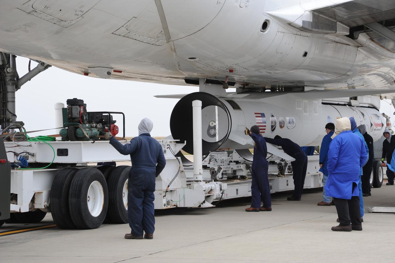 VANDENBERG AIR FORCE BASE, Calif. – Preparations are under way to roll the transporter from under NASA’s Nuclear Spectroscopic Telescope Array, or NuSTAR, mated to Orbital Sciences’ Pegasus XL rocket, which was just attached beneath Orbital’s L-1011 carrier aircraft at the “hot pad,” located on the ramp adjacent to the runway on Vandenberg Air Force Base in California.    The duo will be flown from Vandenberg to the U.S. Army's Ronald Reagan Ballistic Missile Defense Test Site on Kwajalein Atoll, part of the Marshall Islands in the Pacific Ocean.  The Pegasus and its NuSTAR payload will be launched June 13 from the carrier aircraft 117 nautical miles south of Kwajalein at latitude 6.75 degrees north of the equator.  The high-energy X-ray telescope will conduct a census of black holes, map radioactive material in young supernovae remnants, and study the origins of cosmic rays and the extreme physics around collapsed stars. For more information, visit http://www.nasa.gov/nustar.  Photo credit: NASA/Chris Wiant, VAFB