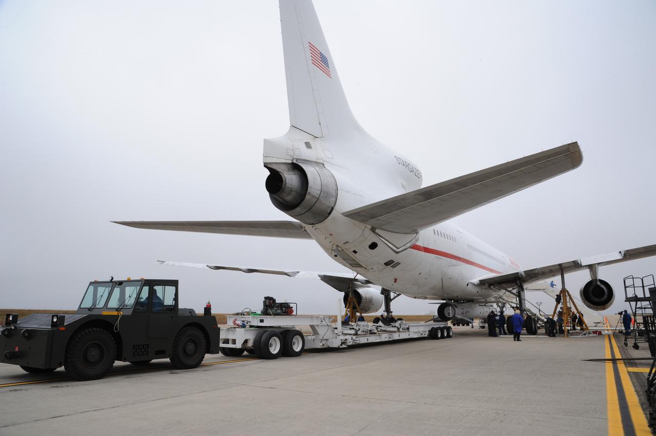 VANDENBERG AIR FORCE BASE, Calif. – The transporter rolls away from Orbital Sciences’ L-1011 carrier aircraft at the “hot pad,” located on the ramp adjacent to the runway on Vandenberg Air Force Base in California.  Operations to attach NASA’s Nuclear Spectroscopic Telescope Array, or NuSTAR, mated to Orbital Sciences’ Pegasus XL rocket, beneath the L-1011 aircraft are complete.    The duo will be flown from Vandenberg to the U.S. Army's Ronald Reagan Ballistic Missile Defense Test Site on Kwajalein Atoll, part of the Marshall Islands in the Pacific Ocean.  The Pegasus and its NuSTAR payload will be launched June 13 from the carrier aircraft 117 nautical miles south of Kwajalein at latitude 6.75 degrees north of the equator.  The high-energy X-ray telescope will conduct a census of black holes, map radioactive material in young supernovae remnants, and study the origins of cosmic rays and the extreme physics around collapsed stars. For more information, visit http://www.nasa.gov/nustar.  Photo credit: NASA/Chris Wiant, VAFB