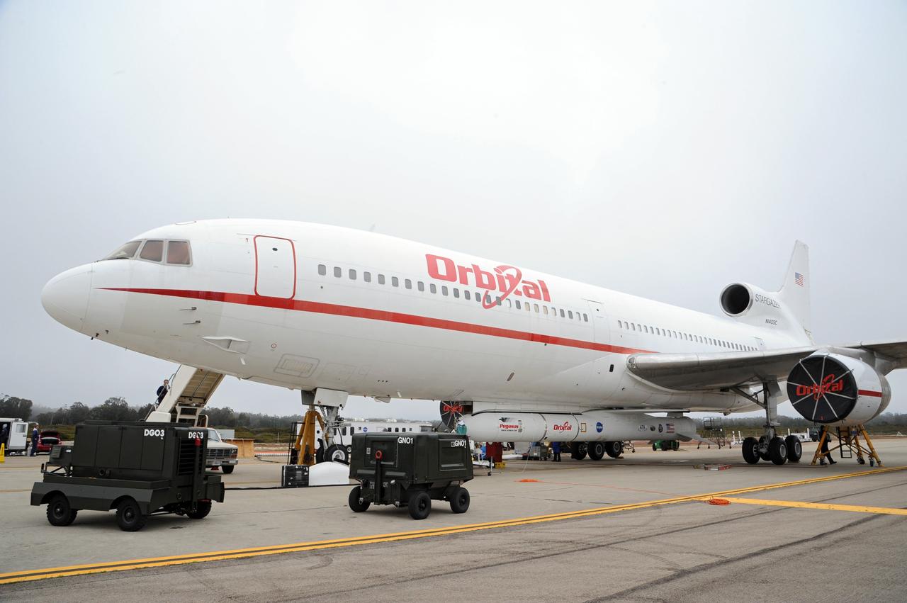 VANDENBERG AIR FORCE BASE, Calif. – Orbital Sciences’ L-1011 carrier aircraft is one step closer to launching NASA’s Nuclear Spectroscopic Telescope Array, or NuSTAR.  The Pegasus XL rocket to which the telescope is mated has been attached beneath the aircraft at the “hot pad,” located on the ramp adjacent to the runway on Vandenberg Air Force Base in California.      The duo will be flown from Vandenberg to the U.S. Army's Ronald Reagan Ballistic Missile Defense Test Site on Kwajalein Atoll, part of the Marshall Islands in the Pacific Ocean.  The Pegasus and its NuSTAR payload will be launched June 13 from the carrier aircraft 117 nautical miles south of Kwajalein at latitude 6.75 degrees north of the equator.  The high-energy X-ray telescope will conduct a census of black holes, map radioactive material in young supernovae remnants, and study the origins of cosmic rays and the extreme physics around collapsed stars. For more information, visit http://www.nasa.gov/nustar.  Photo credit: NASA/Chris Wiant, VAFB