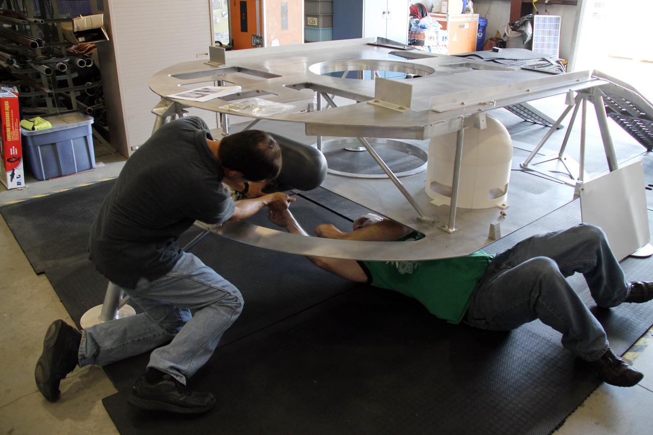 CAPE CANAVERAL, Fla. – Engineers complete the assembly of the prototype lander for NASA’s Regolith and Environment Science and Oxygen and Lunar Volatile Extraction, or RESOLVE, project in a test facility behind the Operations and Checkout Building at NASA’s Kennedy Space Center in Florida.      RESOLVE consists of a rover and drill provided by the Canadian Space Agency to support a NASA payload that is designed to prospect for water, ice and other lunar resources. RESOLVE also will demonstrate how future explorers can take advantage of resources at potential landing sites by manufacturing oxygen from soil. NASA will be conducting field tests in July outside of Hilo, Hawaii, with equipment and concept vehicles that demonstrate how explorers might prospect for resources and make their own oxygen for survival while on other planetary bodies.  For more information, visit http://www.nasa.gov/exploration/analogs/index.html.  Photo credit: NASA/Ben Smegelsky