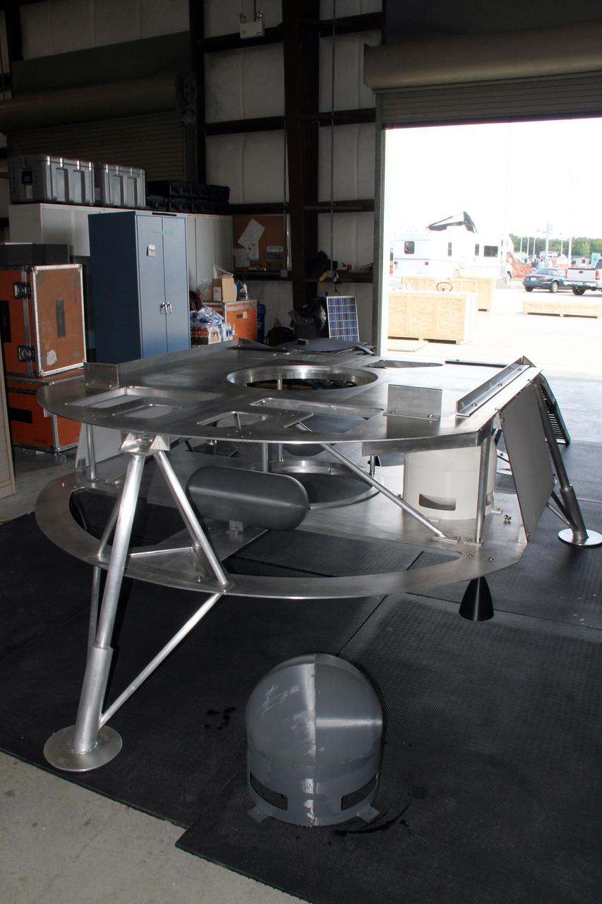 CAPE CANAVERAL, Fla. – Assembly of the prototype lander for NASA’s Regolith and Environment Science and Oxygen and Lunar Volatile Extraction, or RESOLVE, project is complete in a test facility behind the Operations and Checkout Building at NASA’s Kennedy Space Center in Florida.      RESOLVE consists of a rover and drill provided by the Canadian Space Agency to support a NASA payload that is designed to prospect for water, ice and other lunar resources. RESOLVE also will demonstrate how future explorers can take advantage of resources at potential landing sites by manufacturing oxygen from soil. NASA will be conducting field tests in July outside of Hilo, Hawaii, with equipment and concept vehicles that demonstrate how explorers might prospect for resources and make their own oxygen for survival while on other planetary bodies.  For more information, visit http://www.nasa.gov/exploration/analogs/index.html.  Photo credit: NASA/Ben Smegelsky