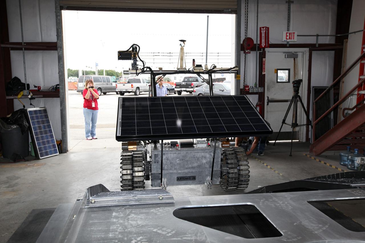 CAPE CANAVERAL, Fla. – In a test facility behind the Operations and Checkout Building at NASA’s Kennedy Space Center in Florida, the prototype rover Artemis Jr. for NASA’s Regolith and Environment Science and Oxygen and Lunar Volatile Extraction, or RESOLVE, project dismounts from the RESOLVE lander during a dry run using ramps attached to the prototype lander.    RESOLVE consists of a rover and drill provided by the Canadian Space Agency to support a NASA payload that is designed to prospect for water, ice and other lunar resources. RESOLVE also will demonstrate how future explorers can take advantage of resources at potential landing sites by manufacturing oxygen from soil. NASA will conduct field tests in July outside of Hilo, Hawaii, with equipment and concept vehicles that demonstrate how explorers might prospect for resources and make their own oxygen for survival while on other planetary bodies.  For more information, visit http://www.nasa.gov/exploration/analogs/index.html.  Photo credit: NASA/Dimitri Gerondidakis