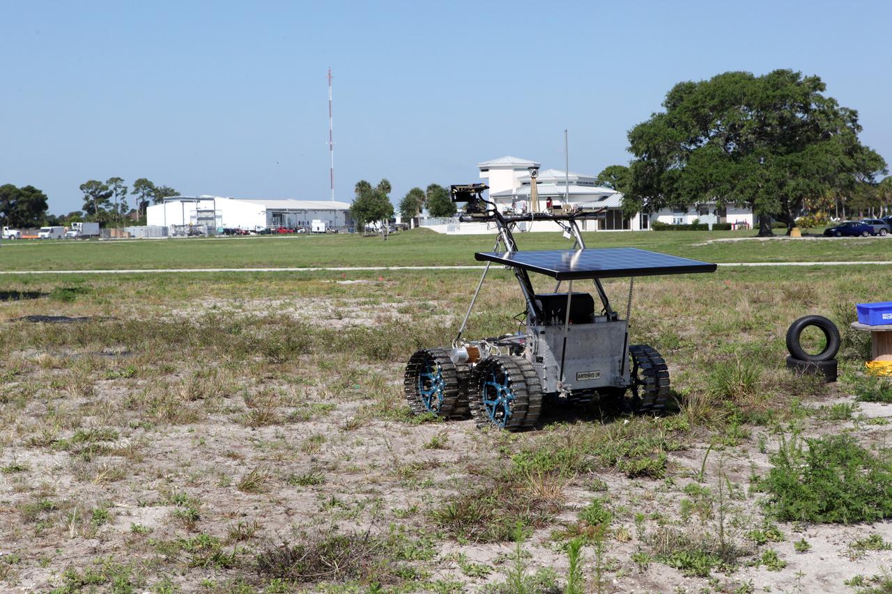 CAPE CANAVERAL, Fla. – The prototype rover Artemis Jr. for NASA’s Regolith and Environment Science and Oxygen and Lunar Volatile Extraction, or RESOLVE, project takes a spin around the field next to the Operations and Checkout Building at NASA’s Kennedy Space Center in Florida.       RESOLVE consists of a rover and drill provided by the Canadian Space Agency to support a NASA payload that is designed to prospect for water, ice and other lunar resources. RESOLVE also will demonstrate how future explorers can take advantage of resources at potential landing sites by manufacturing oxygen from soil. NASA will conduct field tests in July outside of Hilo, Hawaii, with equipment and concept vehicles that demonstrate how explorers might prospect for resources and make their own oxygen for survival while on other planetary bodies.  For more information, visit http://www.nasa.gov/exploration/analogs/index.html.  Photo credit: NASA/Dimitri Gerondidakis