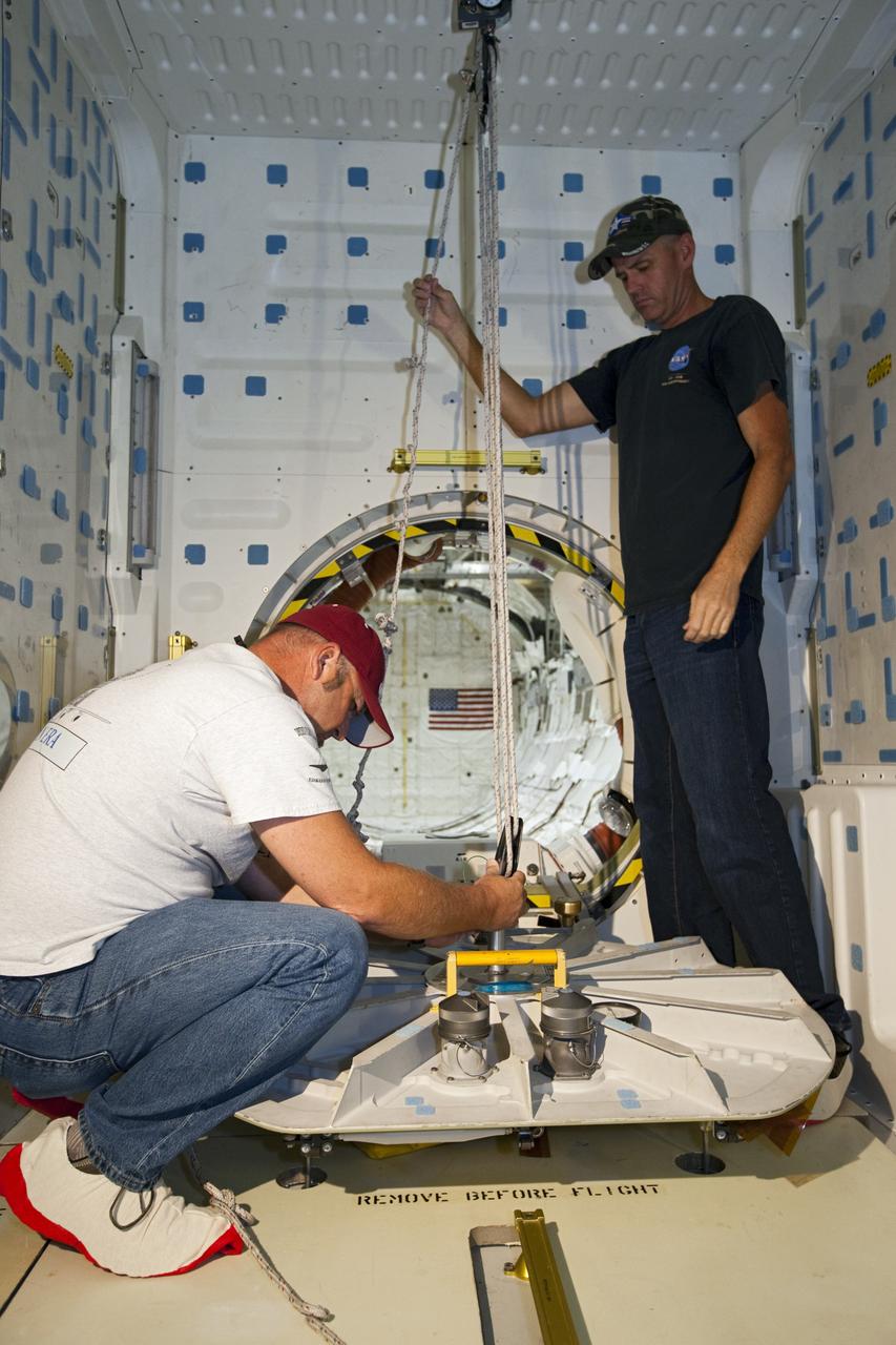 CAPE CANAVERAL, Fla. – In Orbiter Processing Facility-2 at NASA’s Kennedy Space Center in Florida, United Space Alliance technicians prepare to lift the hatch of space shuttle Endeavour’s airlock for its final closure during processing for the shuttle’s retirement. Endeavour is being prepared for public display at the California Science Center in Los Angeles. Its ferry flight to California is targeted for mid-September. Endeavour, designated OV-105, was the last space shuttle added to NASA’s orbiter fleet. Over the course of its 19-year career, Endeavour spent 299 days in space during 25 missions. For more information, visit http://www.nasa.gov/transition. Photo credit: NASA/Dimitri Gerondidakis