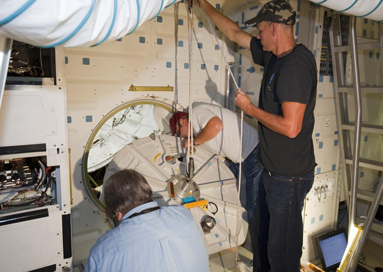 CAPE CANAVERAL, Fla. – In Orbiter Processing Facility-2 at NASA’s Kennedy Space Center in Florida, United Space Alliance technicians align the hatch of space shuttle Endeavour’s airlock for its final closure during processing for the shuttle’s retirement. Endeavour is being prepared for public display at the California Science Center in Los Angeles. Its ferry flight to California is targeted for mid-September. Endeavour, designated OV-105, was the last space shuttle added to NASA’s orbiter fleet. Over the course of its 19-year career, Endeavour spent 299 days in space during 25 missions. For more information, visit http://www.nasa.gov/transition. Photo credit: NASA/Dimitri Gerondidakis