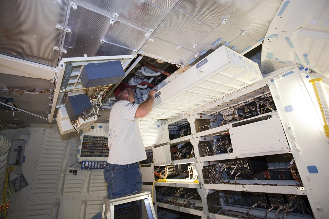 CAPE CANAVERAL, Fla. – In Orbiter Processing Facility-2 at NASA’s Kennedy Space Center in Florida, United Space Alliance technicians reinstall the food pantry locker in space shuttle Endeavour’s middeck during processing for the shuttle’s retirement. Endeavour is being prepared for public display at the California Science Center in Los Angeles. Its ferry flight to California is targeted for mid-September. Endeavour, designated OV-105, was the last space shuttle added to NASA’s orbiter fleet. Over the course of its 19-year career, Endeavour spent 299 days in space during 25 missions. For more information, visit http://www.nasa.gov/transition. Photo credit: NASA/Dimitri Gerondidakis