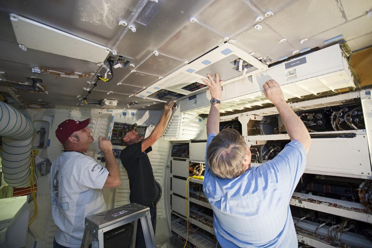 CAPE CANAVERAL, Fla. – In Orbiter Processing Facility-2 at NASA’s Kennedy Space Center in Florida, United Space Alliance technicians reinstall the food pantry locker in space shuttle Endeavour’s middeck during processing for the shuttle’s retirement. Endeavour is being prepared for public display at the California Science Center in Los Angeles. Its ferry flight to California is targeted for mid-September. Endeavour, designated OV-105, was the last space shuttle added to NASA’s orbiter fleet. Over the course of its 19-year career, Endeavour spent 299 days in space during 25 missions. For more information, visit http://www.nasa.gov/transition. Photo credit: NASA/Dimitri Gerondidakis