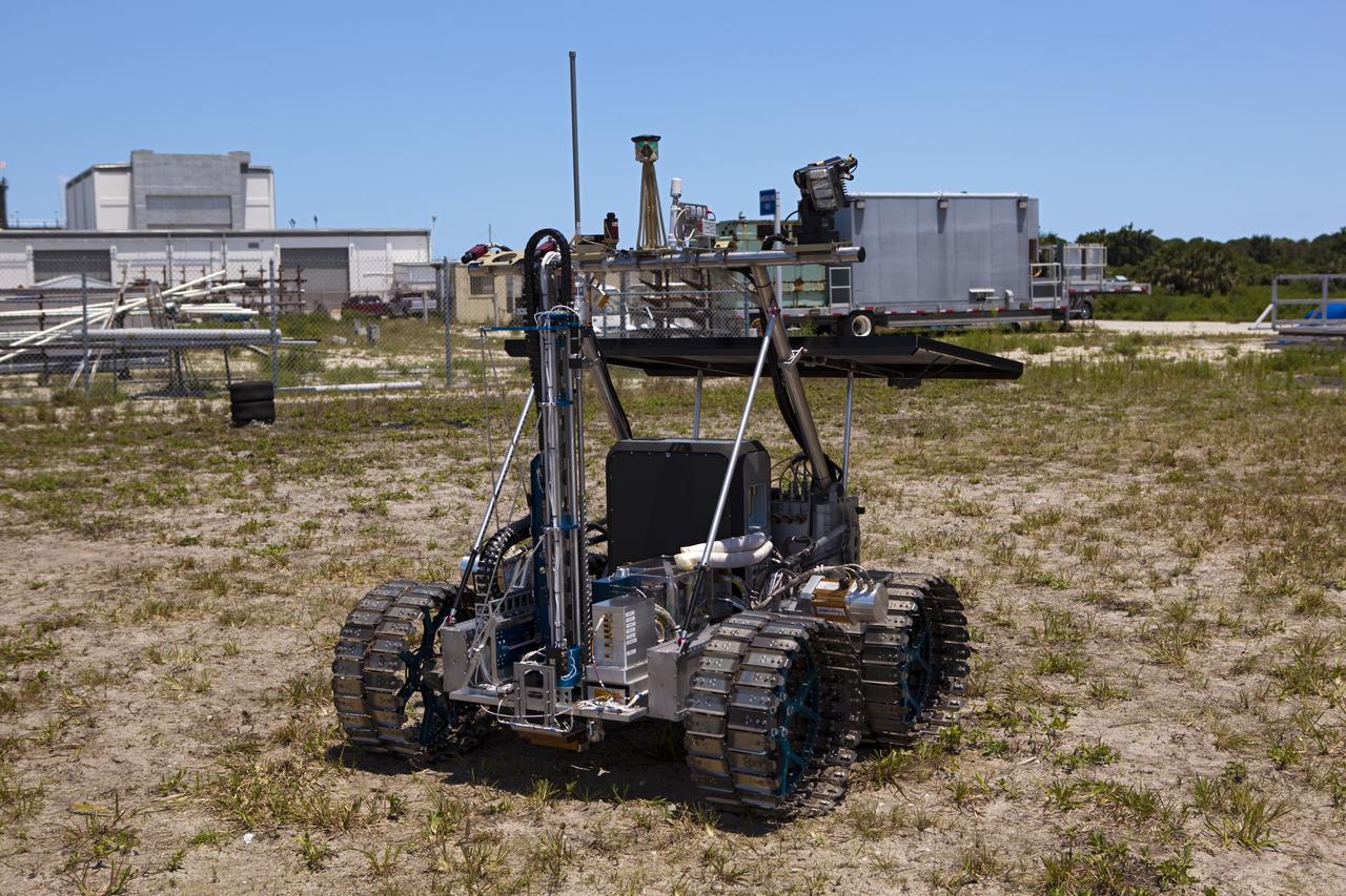 CAPE CANAVERAL, Fla. – A demonstration of the prototype rover Artemis Jr. for NASA’s Regolith and Environment Science and Oxygen and Lunar Volatile Extraction, or RESOLVE, project is conducted in a field beside the Operations and Checkout Building at NASA’s Kennedy Space Center in Florida.      The rover and its drill are provided by the Canadian Space Agency and work in concert with NASA science instruments to prospect for water, ice and other lunar resources.  RESOLVE also will demonstrate how future explorers can take advantage of resources at potential landing sites by manufacturing oxygen from soil. NASA will conduct field tests in July outside of Hilo, Hawaii, with equipment and concept vehicles that demonstrate how explorers might prospect for resources and make their own oxygen for survival while on other planetary bodies.  For more information, visit http://www.nasa.gov/exploration/analogs/index.html.  Photo credit: NASA/Dimitri Gerondidakis
