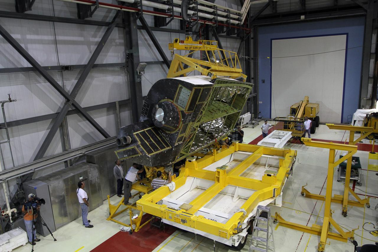 CAPE CANAVERAL, Fla. – In Orbiter Processing Facility-1 at NASA’s Kennedy Space Center in Florida, the underbelly of an orbital maneuvering system, or OMS, pod comes into view as it is lifted from its transporter. The pod will be reinstalled on space shuttle Atlantis. The orbital maneuvering system provided the shuttle with thrust for orbit insertion, rendezvous and deorbit, and could provide up to 1,000 pounds of propellant to the aft reaction control system. The OMS is housed in two independent pods located on each side of the shuttle's aft fuselage. Each pod contains one OMS engine and the hardware needed to pressurize, store and distribute the propellants to perform the velocity maneuvers. Atlantis’ OMS pods were removed and sent to White Sands Test Facility in New Mexico to be cleaned of residual toxic propellant. The work is part of the Space Shuttle Program’s transition and retirement processing of the shuttle fleet. A groundbreaking was held Jan. 18 for Atlantis' future home, a 65,000-square-foot exhibit hall in Shuttle Plaza at the Kennedy Space Center Visitor Complex. Atlantis is scheduled to roll over to the visitor complex in November in preparation for the exhibit’s grand opening in July 2013. For more information, visit http://www.nasa.gov/transition. Photo credit: NASA/Kim Shiflett