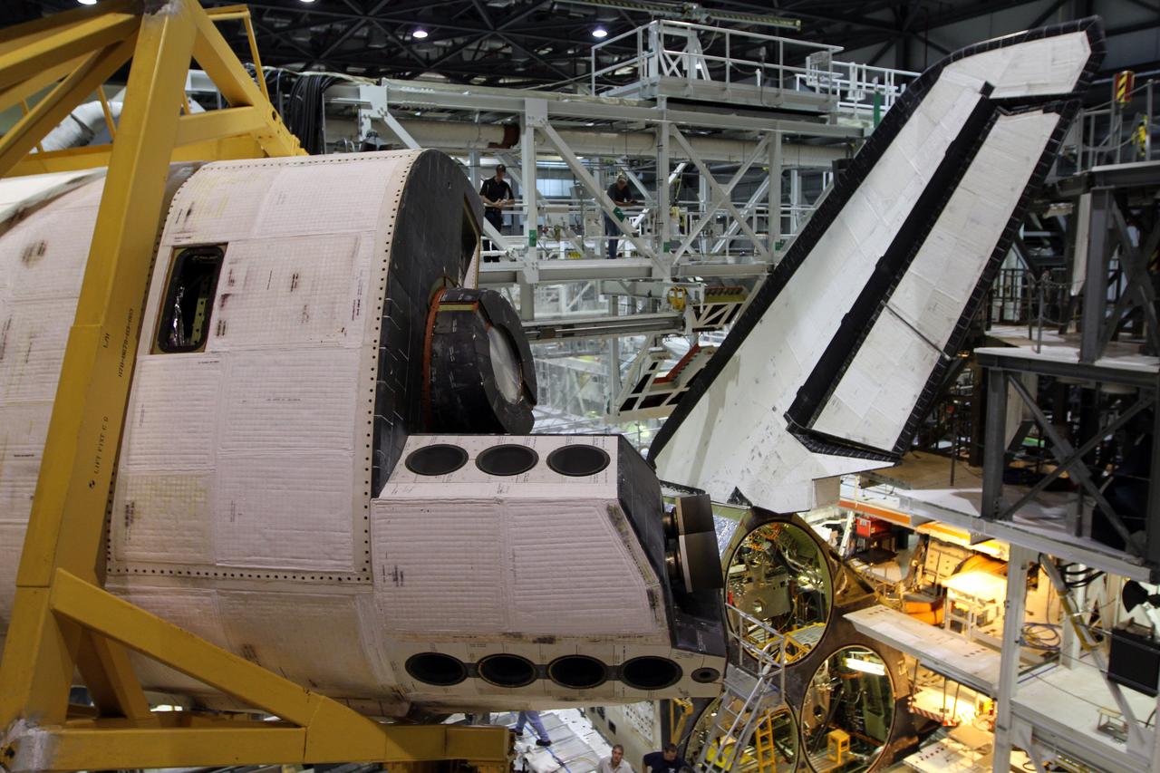 CAPE CANAVERAL, Fla. – An orbital maneuvering system, or OMS, pod appears to be in flight as it glides across the ceiling in Orbiter Processing Facility-1 at NASA’s Kennedy Space Center in Florida. The pod will be reinstalled on space shuttle Atlantis. The orbital maneuvering system provided the shuttle with thrust for orbit insertion, rendezvous and deorbit, and could provide up to 1,000 pounds of propellant to the aft reaction control system. The OMS is housed in two independent pods located on each side of the shuttle's aft fuselage. Each pod contains one OMS engine and the hardware needed to pressurize, store and distribute the propellants to perform the velocity maneuvers. Atlantis’ OMS pods were removed and sent to White Sands Test Facility in New Mexico to be cleaned of residual toxic propellant. The work is part of the Space Shuttle Program’s transition and retirement processing of the shuttle fleet. A groundbreaking was held Jan. 18 for Atlantis' future home, a 65,000-square-foot exhibit hall in Shuttle Plaza at the Kennedy Space Center Visitor Complex. Atlantis is scheduled to roll over to the visitor complex in November in preparation for the exhibit’s grand opening in July 2013. For more information, visit http://www.nasa.gov/transition. Photo credit: NASA/Kim Shiflett