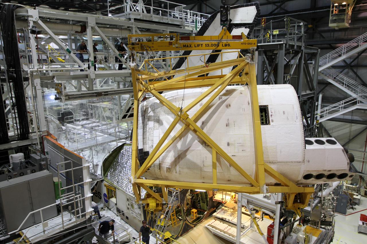 CAPE CANAVERAL, Fla. – In Orbiter Processing Facility-1 at NASA’s Kennedy Space Center in Florida, an orbital maneuvering system, or OMS, pod glides across the ceiling toward space shuttle Atlantis on which it will be installed. The orbital maneuvering system provided the shuttle with thrust for orbit insertion, rendezvous and deorbit, and could provide up to 1,000 pounds of propellant to the aft reaction control system. The OMS is housed in two independent pods located on each side of the shuttle's aft fuselage. Each pod contains one OMS engine and the hardware needed to pressurize, store and distribute the propellants to perform the velocity maneuvers. Atlantis’ OMS pods were removed and sent to White Sands Test Facility in New Mexico to be cleaned of residual toxic propellant. The work is part of the Space Shuttle Program’s transition and retirement processing of the shuttle fleet. A groundbreaking was held Jan. 18 for Atlantis' future home, a 65,000-square-foot exhibit hall in Shuttle Plaza at the Kennedy Space Center Visitor Complex. Atlantis is scheduled to roll over to the visitor complex in November in preparation for the exhibit’s grand opening in July 2013. For more information, visit http://www.nasa.gov/transition. Photo credit: NASA/Kim Shiflett