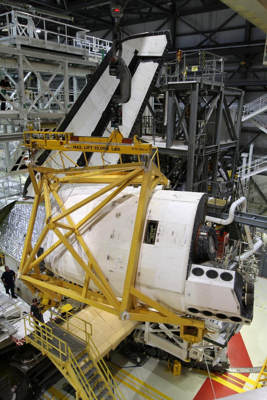 CAPE CANAVERAL, Fla. – In Orbiter Processing Facility-1 at NASA’s Kennedy Space Center in Florida, an orbital maneuvering system, or OMS, pod is lifted toward space shuttle Atlantis on which it will be installed. The orbital maneuvering system provided the shuttle with thrust for orbit insertion, rendezvous and deorbit, and could provide up to 1,000 pounds of propellant to the aft reaction control system. The OMS is housed in two independent pods located on each side of the shuttle's aft fuselage. Each pod contains one OMS engine and the hardware needed to pressurize, store and distribute the propellants to perform the velocity maneuvers. Atlantis’ OMS pods were removed and sent to White Sands Test Facility in New Mexico to be cleaned of residual toxic propellant. The work is part of the Space Shuttle Program’s transition and retirement processing of the shuttle fleet. A groundbreaking was held Jan. 18 for Atlantis' future home, a 65,000-square-foot exhibit hall in Shuttle Plaza at the Kennedy Space Center Visitor Complex. Atlantis is scheduled to roll over to the visitor complex in November in preparation for the exhibit’s grand opening in July 2013. For more information, visit http://www.nasa.gov/transition. Photo credit: NASA/Kim Shiflett