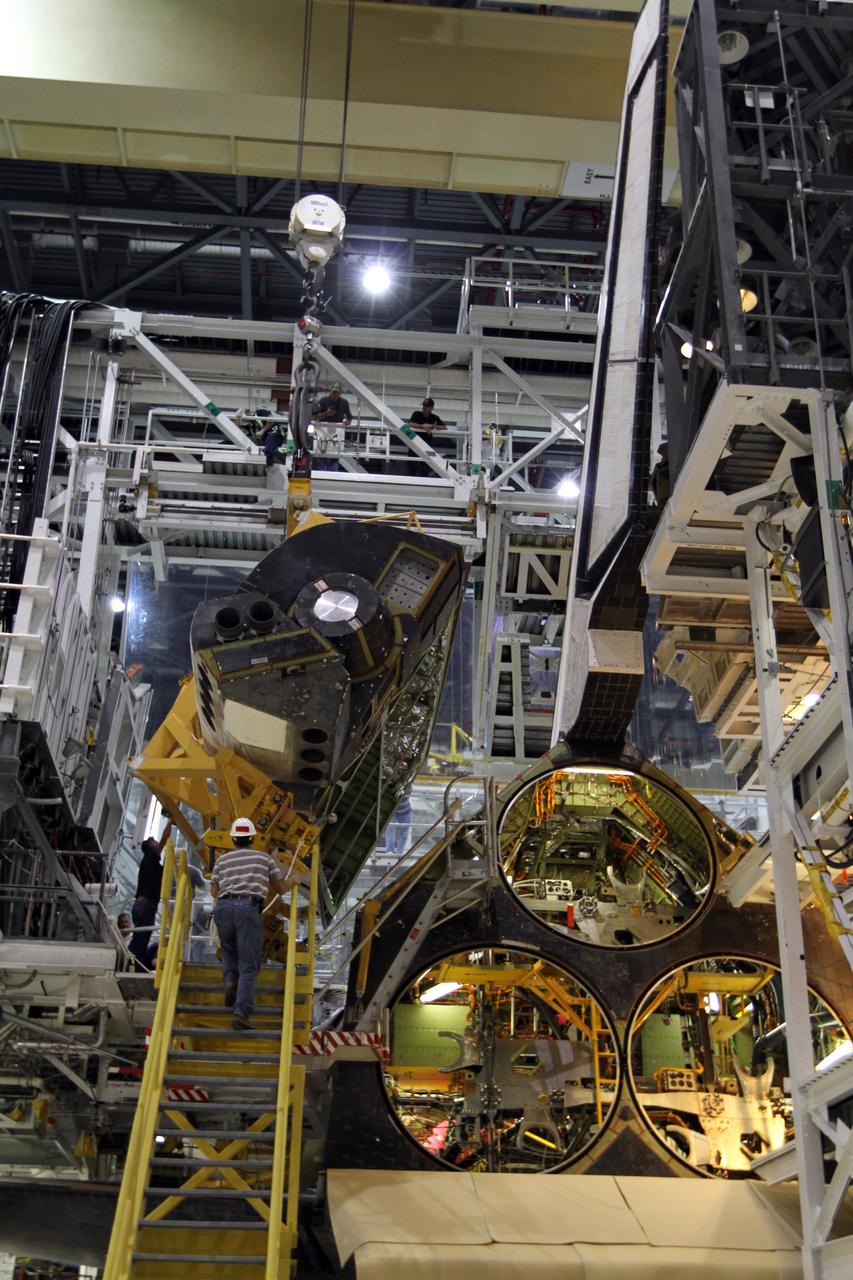CAPE CANAVERAL, Fla. – In Orbiter Processing Facility-1 at NASA’s Kennedy Space Center in Florida, the left orbital maneuvering system, or OMS, pod is rotated into position on space shuttle Atlantis for reinstallation. The orbital maneuvering system provided the shuttle with thrust for orbit insertion, rendezvous and deorbit, and could provide up to 1,000 pounds of propellant to the aft reaction control system. The OMS is housed in two independent pods located on each side of the shuttle's aft fuselage. Each pod contains one OMS engine and the hardware needed to pressurize, store and distribute the propellants to perform the velocity maneuvers. Atlantis’ OMS pods were removed and sent to White Sands Test Facility in New Mexico to be cleaned of residual toxic propellant. The work is part of the Space Shuttle Program’s transition and retirement processing of the shuttle fleet. A groundbreaking was held Jan. 18 for Atlantis' future home, a 65,000-square-foot exhibit hall in Shuttle Plaza at the Kennedy Space Center Visitor Complex. Atlantis is scheduled to roll over to the visitor complex in November in preparation for the exhibit’s grand opening in July 2013. For more information, visit http://www.nasa.gov/transition. Photo credit: NASA/Kim Shiflett