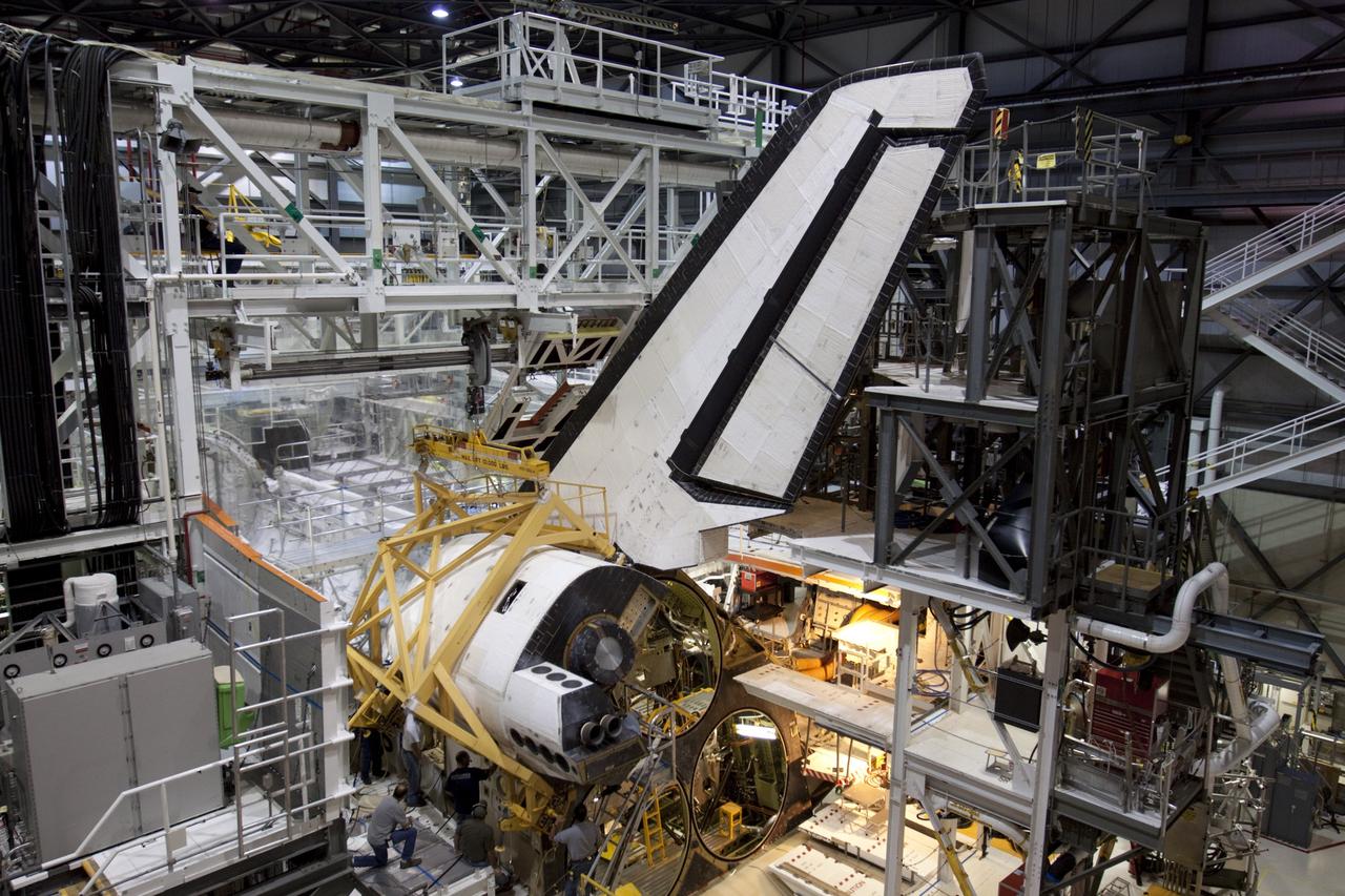 CAPE CANAVERAL, Fla. – In Orbiter Processing Facility-1 at NASA’s Kennedy Space Center in Florida, United Space Alliance technicians reinstall the left orbital maneuvering system, or OMS, pod on space shuttle Atlantis. The orbital maneuvering system provided the shuttle with thrust for orbit insertion, rendezvous and deorbit, and could provide up to 1,000 pounds of propellant to the aft reaction control system. The OMS is housed in two independent pods located on each side of the shuttle's aft fuselage. Each pod contains one OMS engine and the hardware needed to pressurize, store and distribute the propellants to perform the velocity maneuvers. Atlantis’ OMS pods were removed and sent to White Sands Test Facility in New Mexico to be cleaned of residual toxic propellant. The work is part of the Space Shuttle Program’s transition and retirement processing of the shuttle fleet. A groundbreaking was held Jan. 18 for Atlantis' future home, a 65,000-square-foot exhibit hall in Shuttle Plaza at the Kennedy Space Center Visitor Complex. Atlantis is scheduled to roll over to the visitor complex in November in preparation for the exhibit’s grand opening in July 2013. For more information, visit http://www.nasa.gov/transition. Photo credit: NASA/Ben Smegelsky