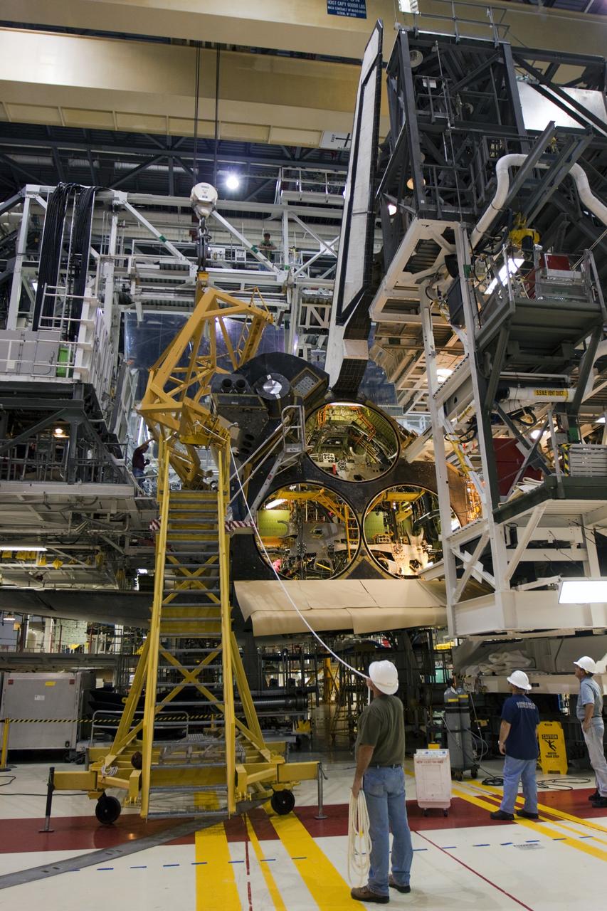CAPE CANAVERAL, Fla. – Inside Orbiter Processing Facility-1 at NASA’s Kennedy Space Center in Florida, United Space Alliance technicians monitor the progress after a large crane lowers the left orbital maneuvering system, or OMS, pod onto space shuttle Atlantis. The OMS provided the shuttle with thrust for orbit insertion, rendezvous and deorbit, and could provide up to 1,000 pounds of propellant to the aft reaction control system.    The OMS is housed in two independent pods located on each side of the shuttle’s aft fuselage. Each pod contains one OMS engine and the hardware needed to pressurize, store and distribute the propellants to perform the velocity maneuvers. Atlantis’ OMS pods were removed and sent to White Sands Test Facility in New Mexico to be cleaned of residual toxic propellant. The work is part of the Space Shuttle Program’s transition and retirement processing of the space shuttle fleet. A groundbreaking was held Jan. 18 for Atlantis’ future home, a 65,000-square-foot exhibit hall in Shuttle Plaza at the Kennedy Space Center Visitor Complex. Atlantis is scheduled to roll over to the visitor complex in November in preparation for the exhibit’s grand opening in July 2013. For more information, visit http://www.nasa.gov/transition. Photo credit: NASA/Ben Smegelsky