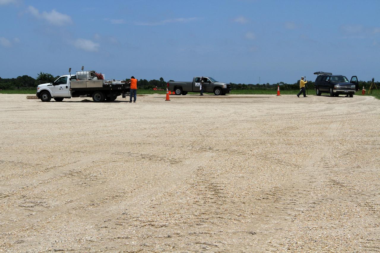 CAPE CANAVERAL, Fla. – Workers set the form for the concrete landing pad during construction of the hazard field for the Project Morpheus lander near the Shuttle Landing Facility at NASA’s Kennedy Space Center in Florida.      Testing of the prototype lander has been ongoing at NASA's Johnson Space Center in Houston in preparation for its first free flight. The SLF will provide the lander with the kind of field necessary for realistic testing, complete with rocks, craters and hazards to avoid. Morpheus utilizes an autonomous landing and hazard avoidance technology, or ALHAT, payload that will allow it to navigate to clear landing sites amidst rocks, craters and other hazards during its descent. Project Morpheus is one of 20 small projects comprising the Advanced Exploration Systems, or AES, program in NASA's Human Exploration and Operations Mission Directorate. AES projects pioneer new approaches for rapidly developing prototype systems, demonstrating key capabilities and validating operational concepts for future human missions beyond Earth orbit.  For more information on Project Morpheus, visit http://www.nasa.gov/centers/johnson/exploration/morpheus/index.html.  Photo credit: NASA/Kim Shiflett