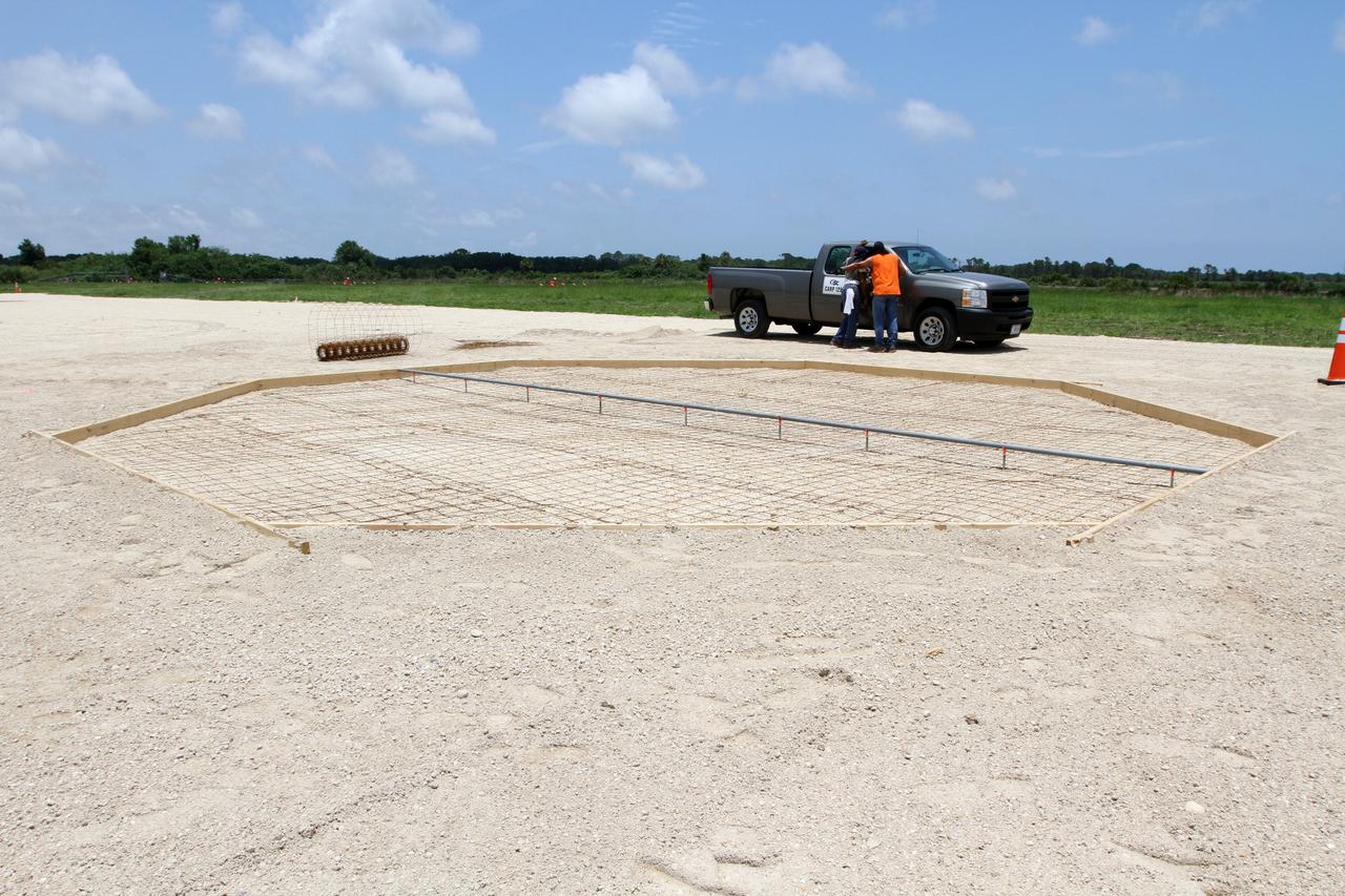 CAPE CANAVERAL, Fla. – The form for the concrete landing pad for the Project Morpheus lander is set near the Shuttle Landing Facility at NASA’s Kennedy Space Center in Florida. Testing of the prototype lander has been ongoing at NASA's Johnson Space Center in Houston in preparation for its first free flight. The SLF will provide the lander with the kind of field necessary for realistic testing, complete with rocks, craters and hazards to avoid. Morpheus utilizes an autonomous landing and hazard avoidance technology, or ALHAT, payload that will allow it to navigate to clear landing sites amidst rocks, craters and other hazards during its descent. Project Morpheus is one of 20 small projects comprising the Advanced Exploration Systems, or AES, program in NASA's Human Exploration and Operations Mission Directorate. AES projects pioneer new approaches for rapidly developing prototype systems, demonstrating key capabilities and validating operational concepts for future human missions beyond Earth orbit. For more information on Project Morpheus, visit http://www.nasa.gov/centers/johnson/exploration/morpheus/index.html. Photo credit: NASA/Kim Shiflett