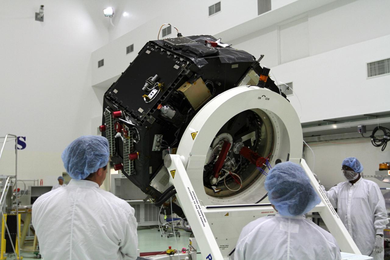 CAPE CANAVERAL, Fla. – Inside the Astrotech payload processing facility near NASA’s Kennedy Space Center in Florida, technicians monitor the progress as the Radiation Belt Storm Probes, or RBSP, spacecraft B is lowered to a horizontal position. The RBSP had been in a vertical position for testing. NASA’s RBSP mission will help us understand the sun’s influence on Earth and near-Earth space by studying the Earth’s radiation belts on various scales of space and time. RBSP will begin its mission of exploration of Earth’s Van Allen radiation belts and the extremes of space weather after its launch aboard a United Launch Alliance Atlas V rocket. Launch is targeted for Aug. 23. For more information, visit http://www.nasa.gov/rbsp. Photo credit: NASA/Kim Shiflett