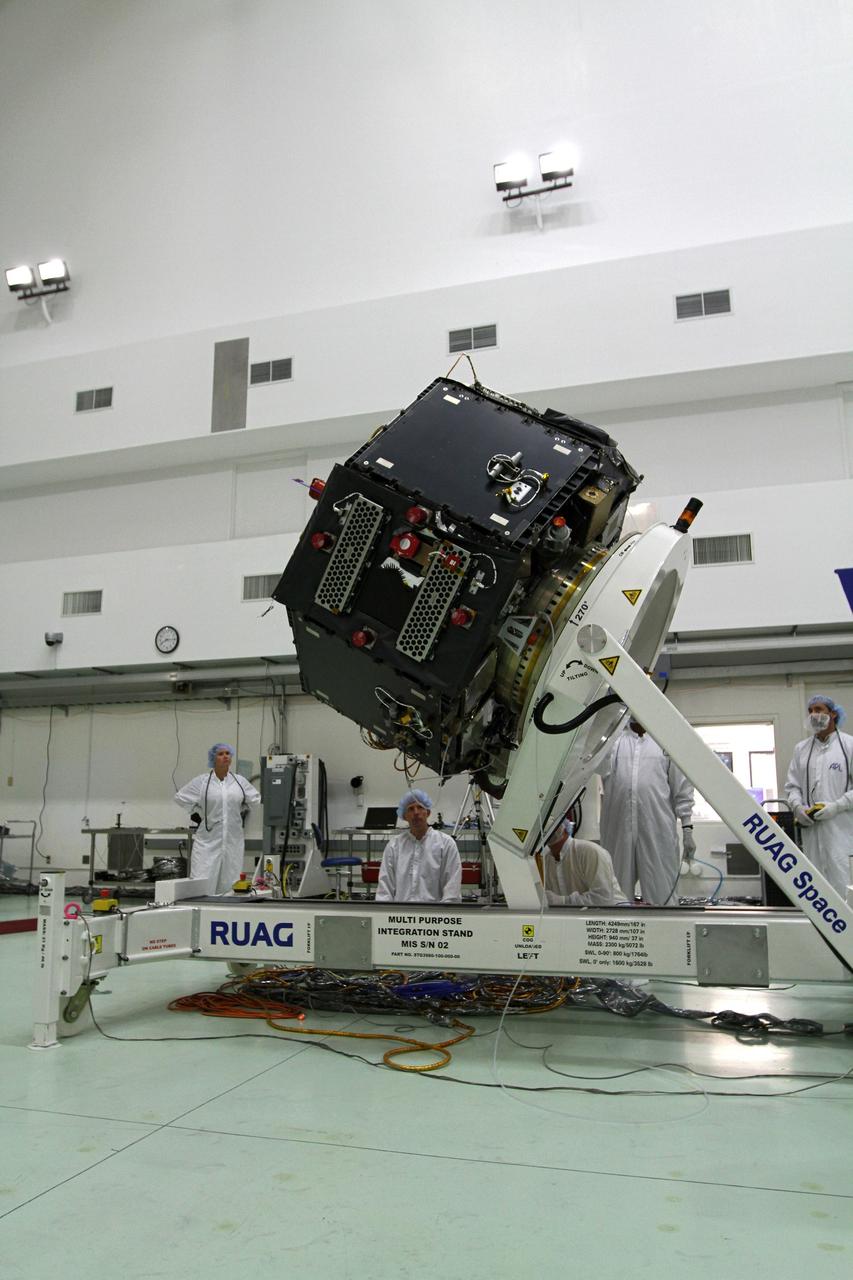 CAPE CANAVERAL, Fla. – Inside the Astrotech payload processing facility near NASA’s Kennedy Space Center in Florida, technicians monitor the progress as the Radiation Belt Storm Probes, or RBSP, spacecraft B is lowered to a horizontal position. The RBSP had been in a vertical position for testing.    NASA’s RBSP mission will help us understand the sun’s influence on Earth and near-Earth space by studying the Earth’s radiation belts on various scales of space and time. RBSP will begin its mission of exploration of Earth’s Van Allen radiation belts and the extremes of space weather after its launch aboard a United Launch Alliance Atlas V rocket. Launch is targeted for Aug. 23. For more information, visit http://www.nasa.gov/rbsp. Photo credit: NASA/Kim Shiflett