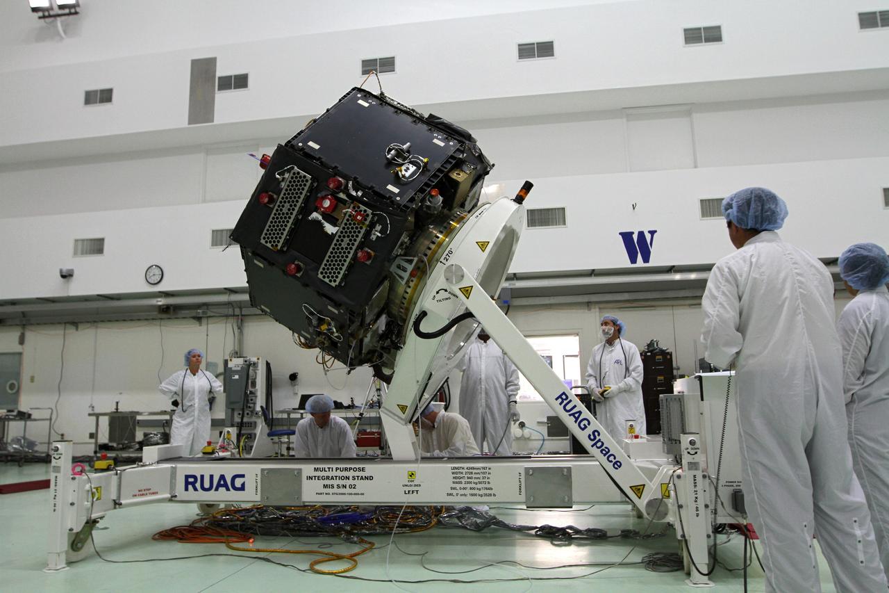 CAPE CANAVERAL, Fla. – Inside the Astrotech payload processing facility near NASA’s Kennedy Space Center in Florida, technicians monitor the progress as the Radiation Belt Storm Probes, or RBSP, spacecraft B is lowered to a horizontal position. The RBSP had been in a vertical position for testing. NASA’s RBSP mission will help us understand the sun’s influence on Earth and near-Earth space by studying the Earth’s radiation belts on various scales of space and time. RBSP will begin its mission of exploration of Earth’s Van Allen radiation belts and the extremes of space weather after its launch aboard a United Launch Alliance Atlas V rocket. Launch is targeted for Aug. 23. For more information, visit http://www.nasa.gov/rbsp. Photo credit: NASA/Kim Shiflett
