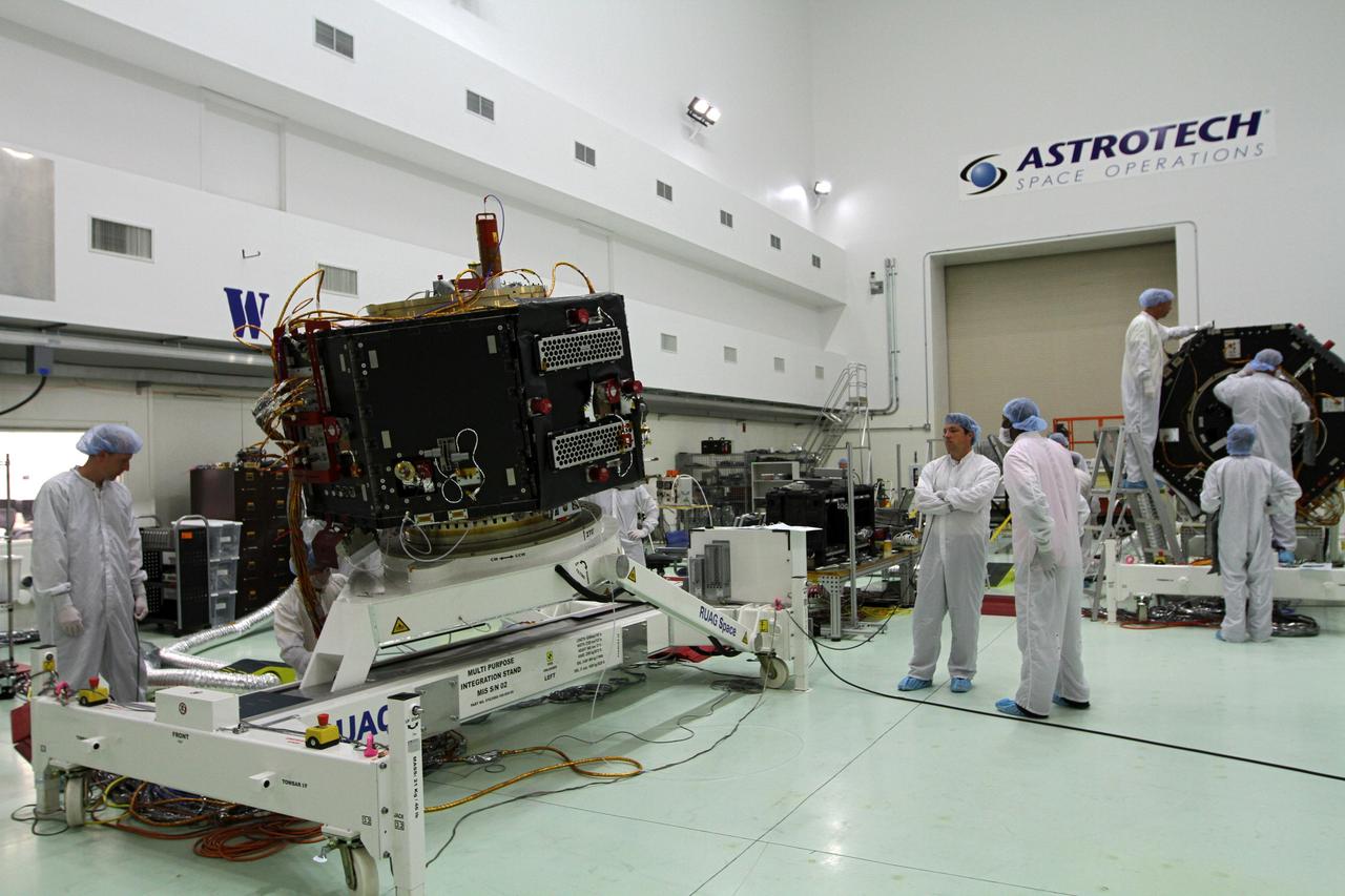 CAPE CANAVERAL, Fla. – Inside the Astrotech payload processing facility near NASA’s Kennedy Space Center in Florida, technicians monitor the progress as the Radiation Belt Storm Probes, or RBSP, spacecraft B is lowered to a horizontal position. The RBSP had been in a vertical position for testing.    NASA’s RBSP mission will help us understand the sun’s influence on Earth and near-Earth space by studying the Earth’s radiation belts on various scales of space and time. RBSP will begin its mission of exploration of Earth’s Van Allen radiation belts and the extremes of space weather after its launch aboard a United Launch Alliance Atlas V rocket. Launch is targeted for Aug. 23. For more information, visit http://www.nasa.gov/rbsp. Photo credit: NASA/Kim Shiflett