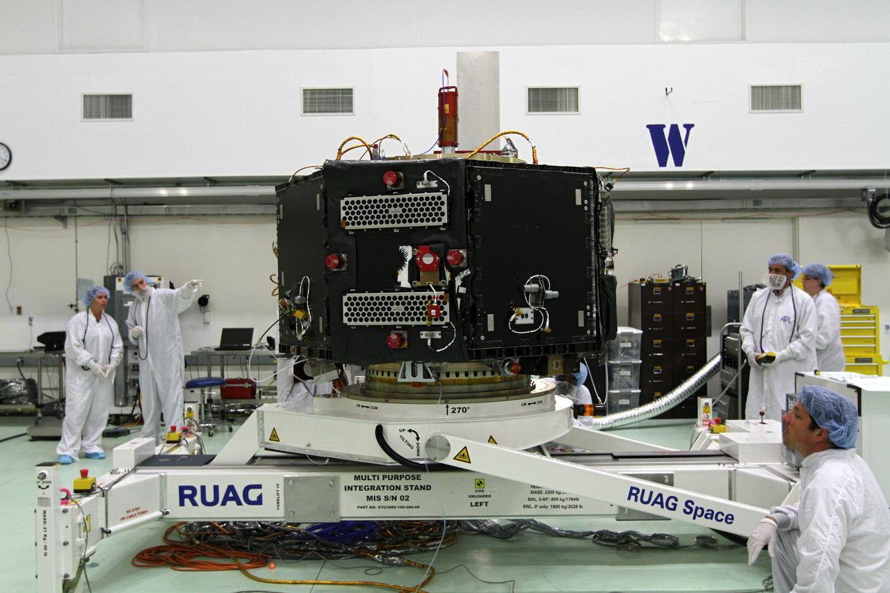 CAPE CANAVERAL, Fla. – Inside the Astrotech payload processing facility near NASA’s Kennedy Space Center in Florida, technicians monitor the progress as the test stand holding the Radiation Belt Storm Probes, or RBSP, spacecraft B is lowered to a horizontal position. The RBSP had been in a vertical position for testing. NASA’s RBSP mission will help us understand the sun’s influence on Earth and near-Earth space by studying the Earth’s radiation belts on various scales of space and time. RBSP will begin its mission of exploration of Earth’s Van Allen radiation belts and the extremes of space weather after its launch aboard a United Launch Alliance Atlas V rocket. Launch is targeted for Aug. 23. For more information, visit http://www.nasa.gov/rbsp. Photo credit: NASA/Kim Shiflett