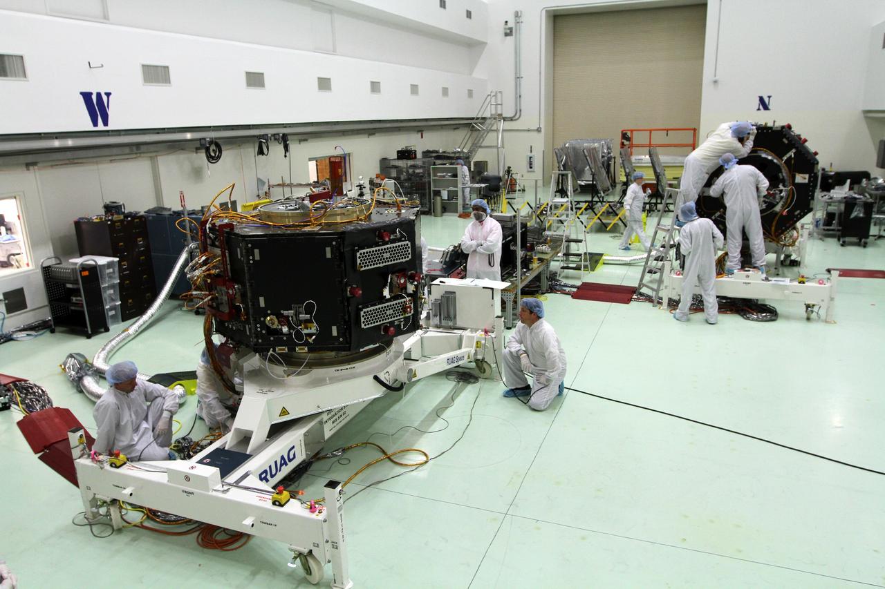 CAPE CANAVERAL, Fla. – Inside the Astrotech payload processing facility near NASA’s Kennedy Space Center in Florida, technicians monitor the progress as the test standing holding the Radiation Belt Storm Probes, or RBSP, spacecraft B is lowered to a horizontal position. The RBSP had been in a vertical position for testing.    NASA’s RBSP mission will help us understand the sun’s influence on Earth and near-Earth space by studying the Earth’s radiation belts on various scales of space and time. RBSP will begin its mission of exploration of Earth’s Van Allen radiation belts and the extremes of space weather after its launch aboard a United Launch Alliance Atlas V rocket. Launch is targeted for Aug. 23. For more information, visit http://www.nasa.gov/rbsp. Photo credit: NASA/Kim Shiflett