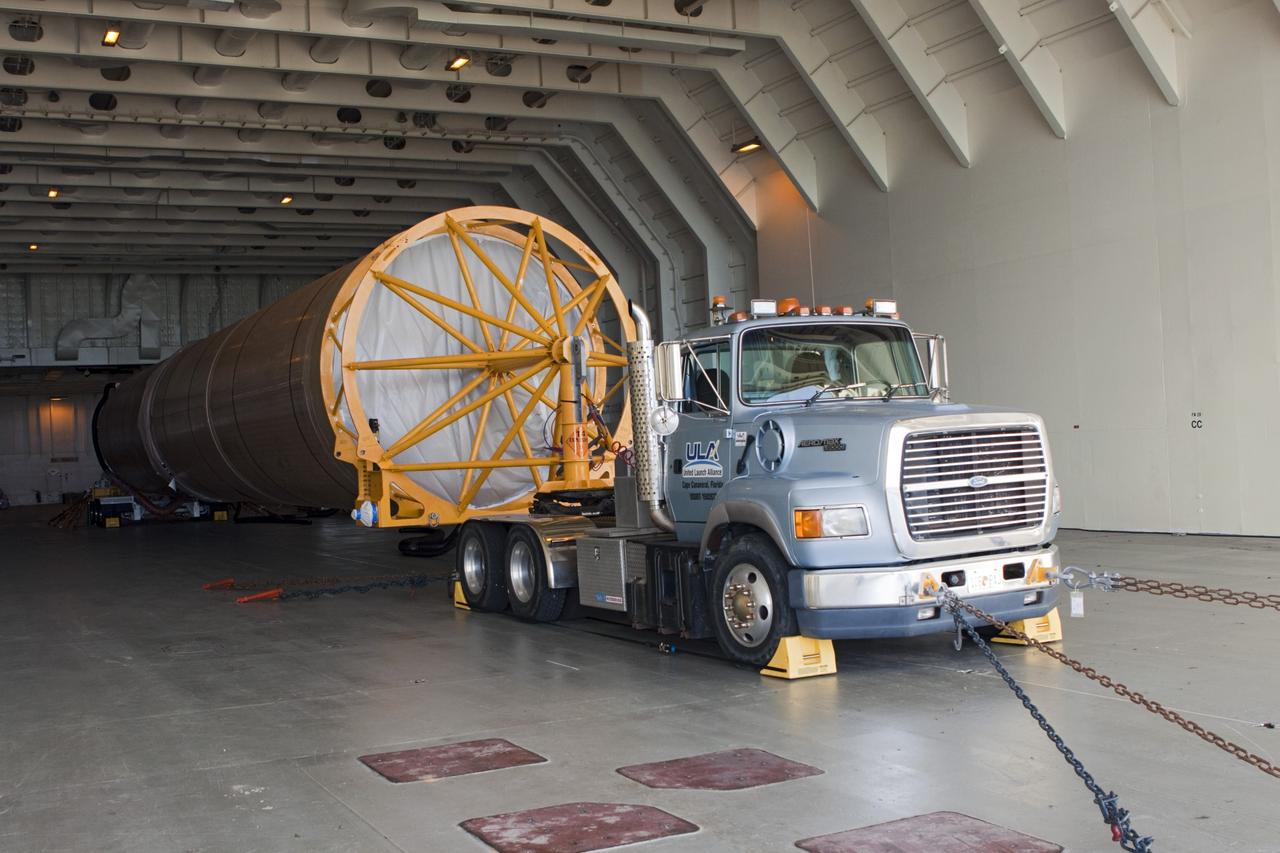 CAPE CANAVERAL, Fla. – At Port Canaveral in Florida, the Atlas V first stage booster for NASA's Radiation Belt Storm Probes mission is attached to a truck for offloading from United Launch Alliance's Delta Mariner barge.    The Radiation Belt Storm Probes, or RBSP, mission will help us understand the sun’s influence on Earth and near-Earth space by studying the Earth’s radiation belts on various scales of space and time. For more information, visit http://www.nasa.gov/rbsp. Photo credit: NASA/Jim Grossmann