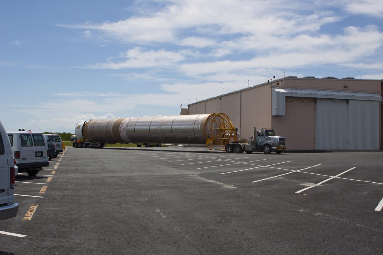 CAPE CANAVERAL, Fla. – The United Launch Alliance Atlas V first stage booster for NASA's Radiation Belt Storm Probes mission arrives at the Atlas Spaceflight Operations Center, or ASOC, at Cape Canaveral Air Force Station in Florida.    The Radiation Belt Storm Probes, or RBSP, mission will help us understand the sun’s influence on Earth and near-Earth space by studying the Earth’s radiation belts on various scales of space and time. For more information, visit http://www.nasa.gov/rbsp. Photo credit: NASA/Jim Grossmann